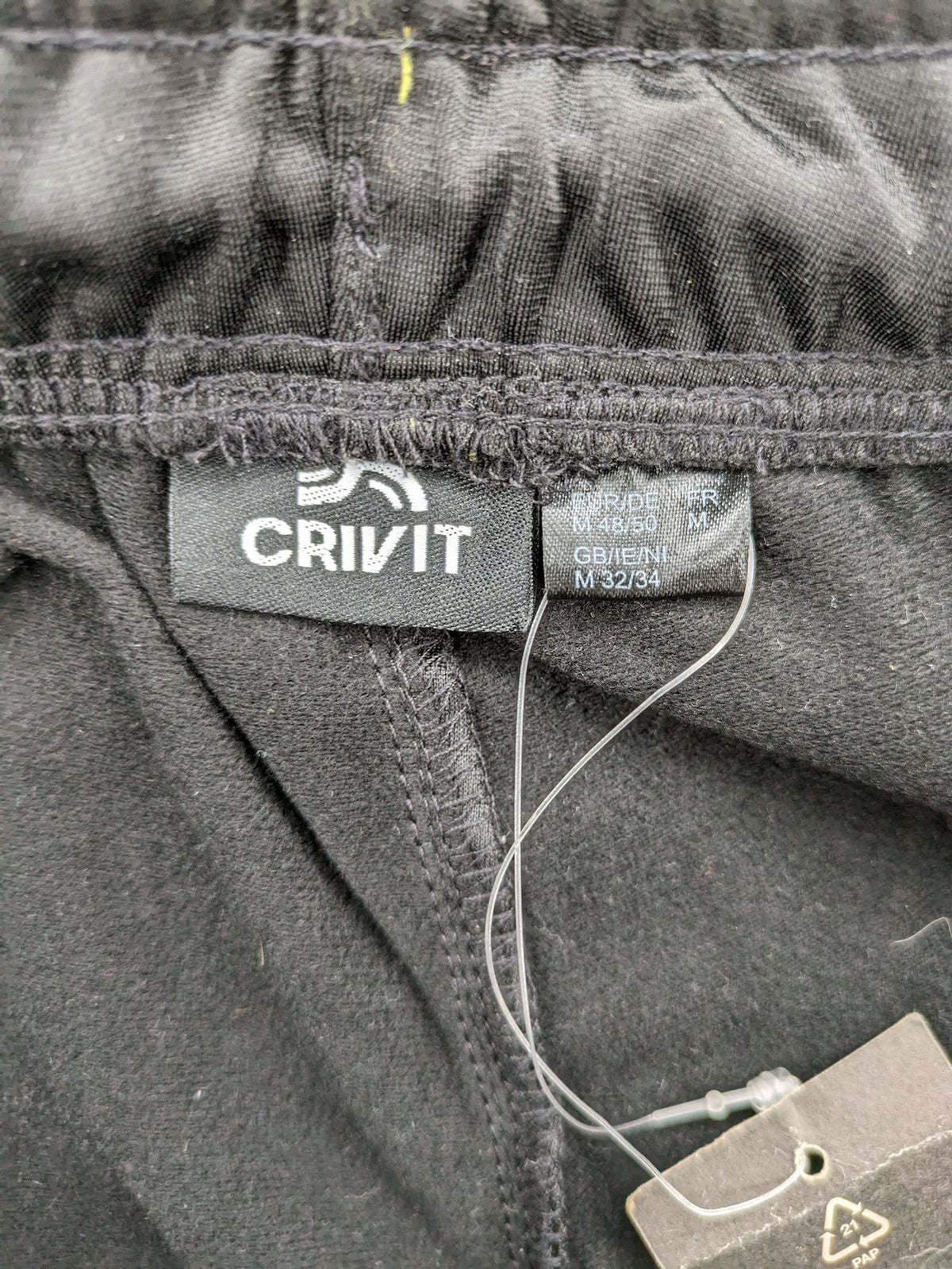 Crivit black weighted training pants with elastic waistband, side pockets, and zippered cuffs.