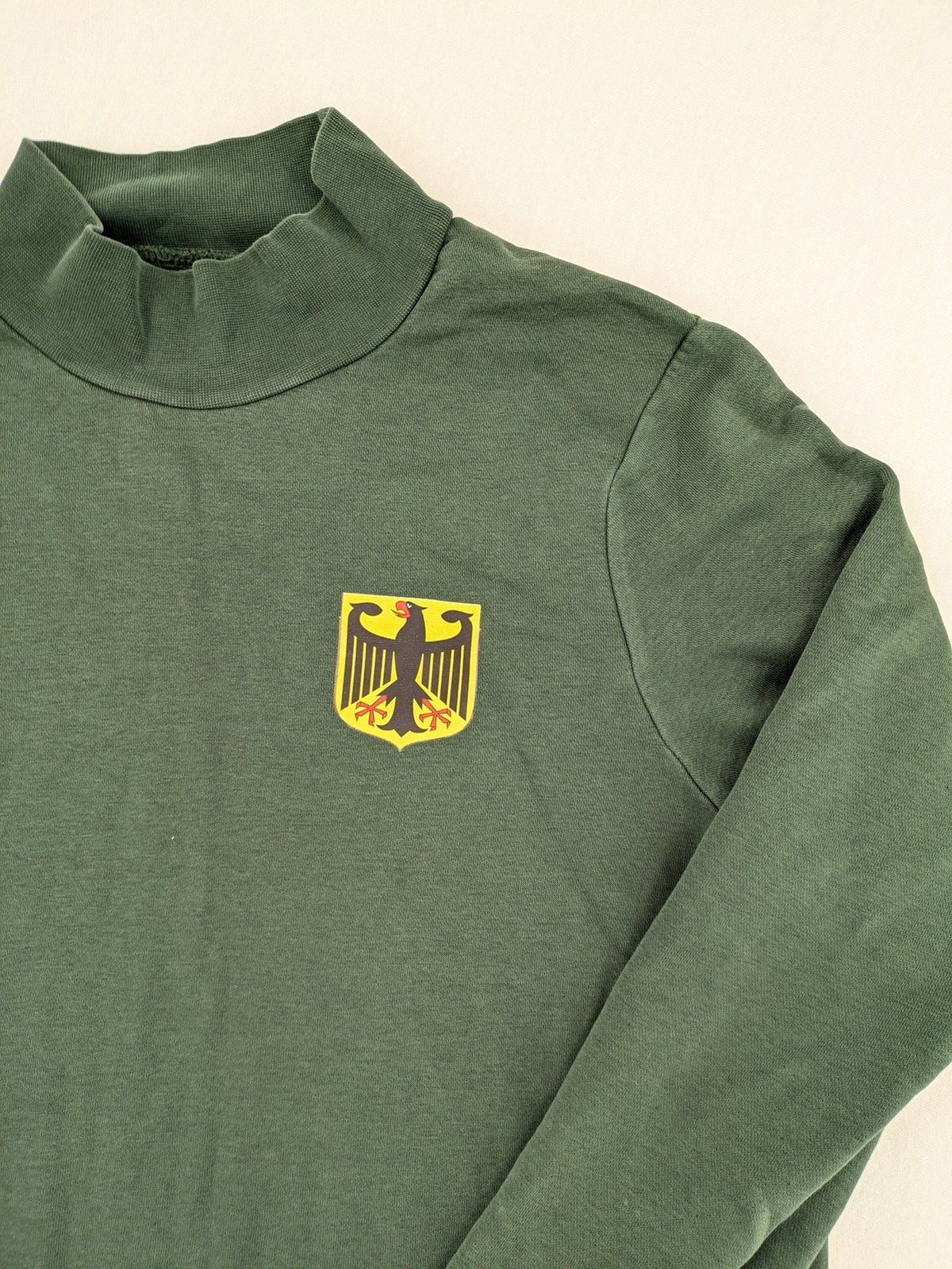 Pull & Bear green sweatshirt with embroidered Germany eagle patch and mock neck.