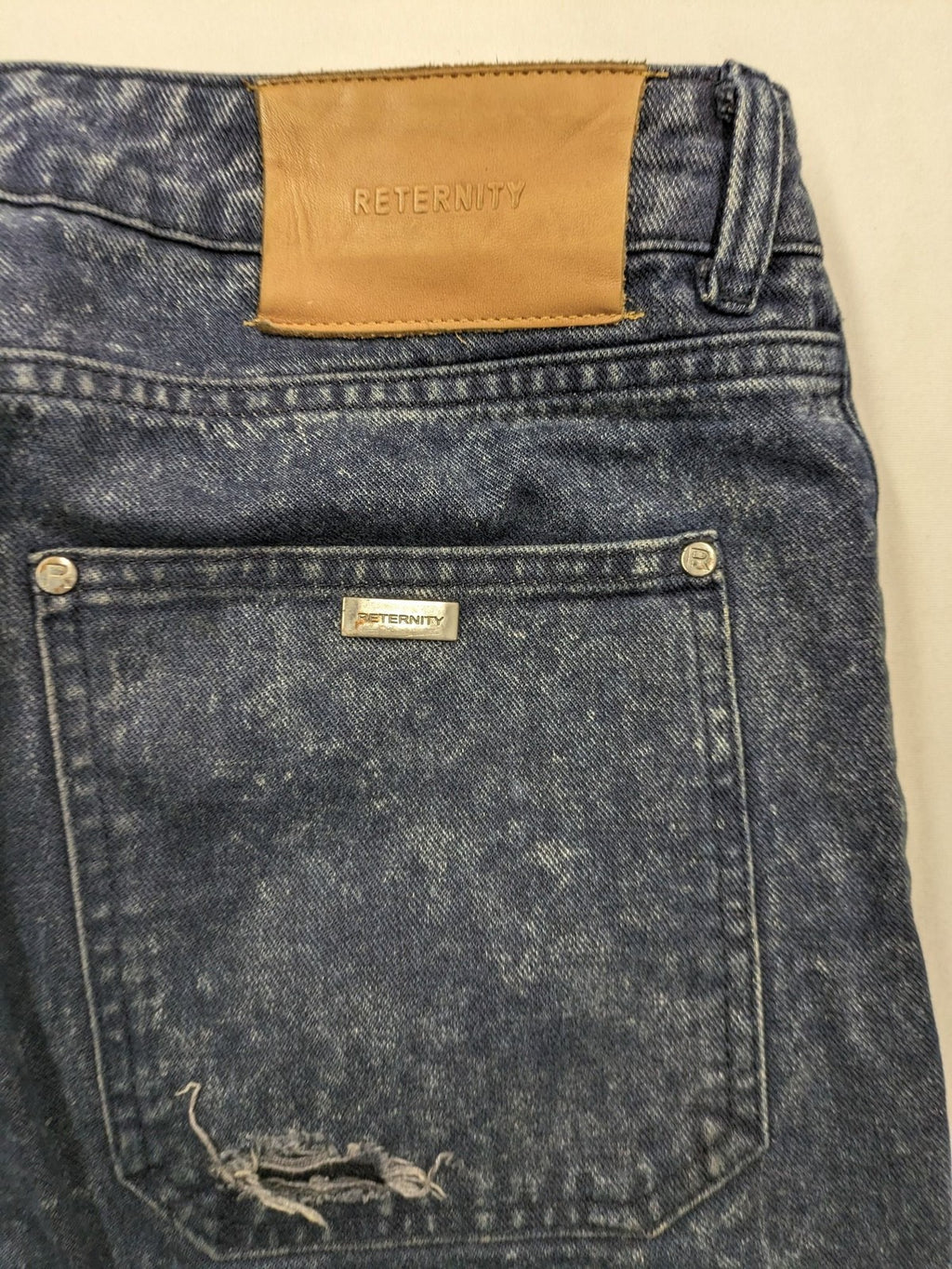 Reternity straight jeans blue black patchwork design with distressed details and frayed seams.