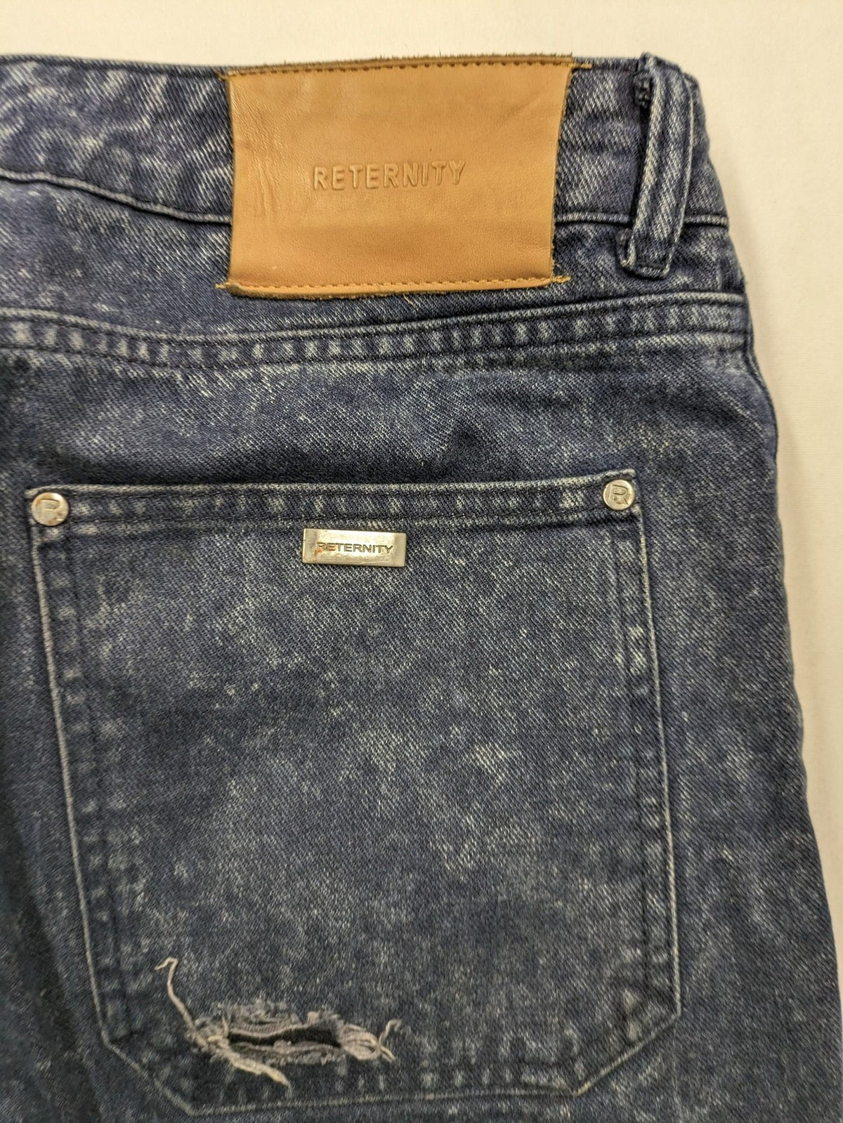 Reternity straight jeans blue black patchwork design with distressed details and frayed seams.