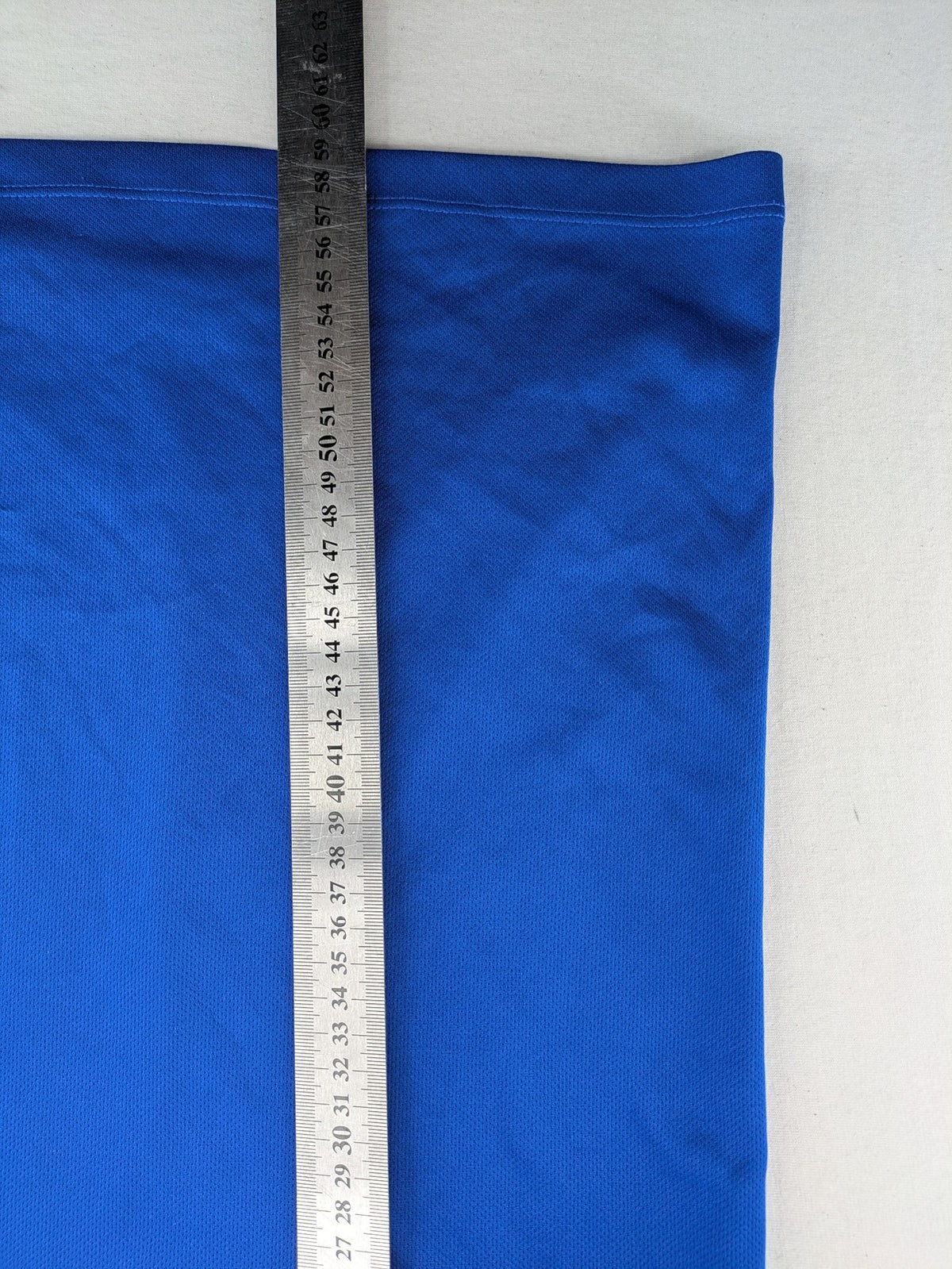 Jako blue short-sleeve training shirt with logo details and breathable polyester material.
