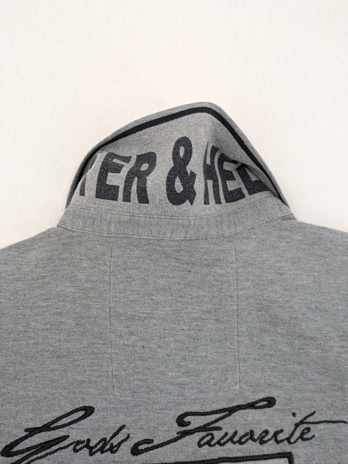 Götter & Helden grey polo shirt with "Gods Favorite" embroidery and contrasting collar details.