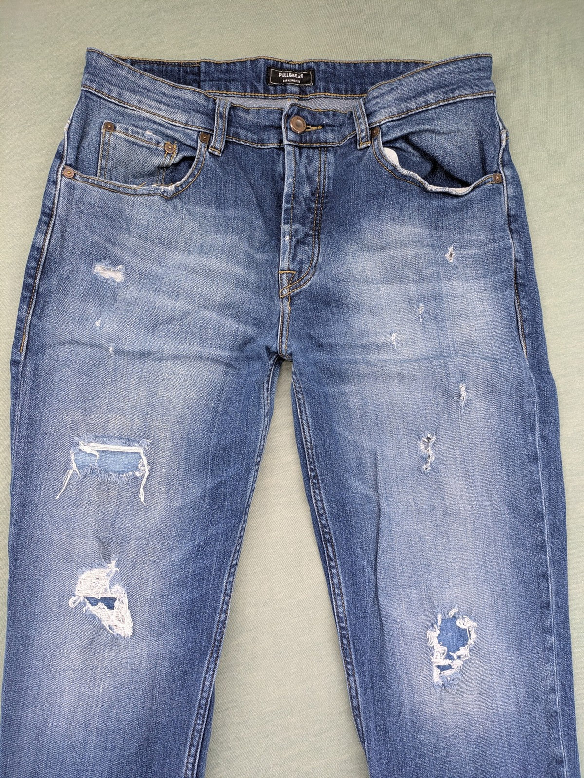 Pull & Bear blue distressed ripped straight jeans with button fly and classic wash.