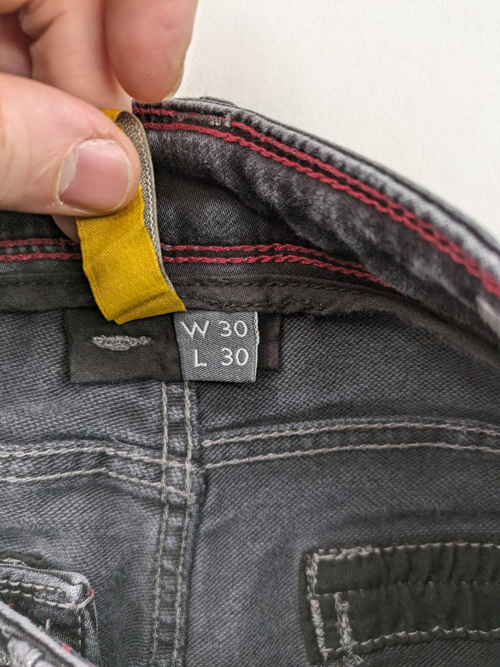 Tom Tompson grey slim tapered jeans with washed denim finish and subtle branding.