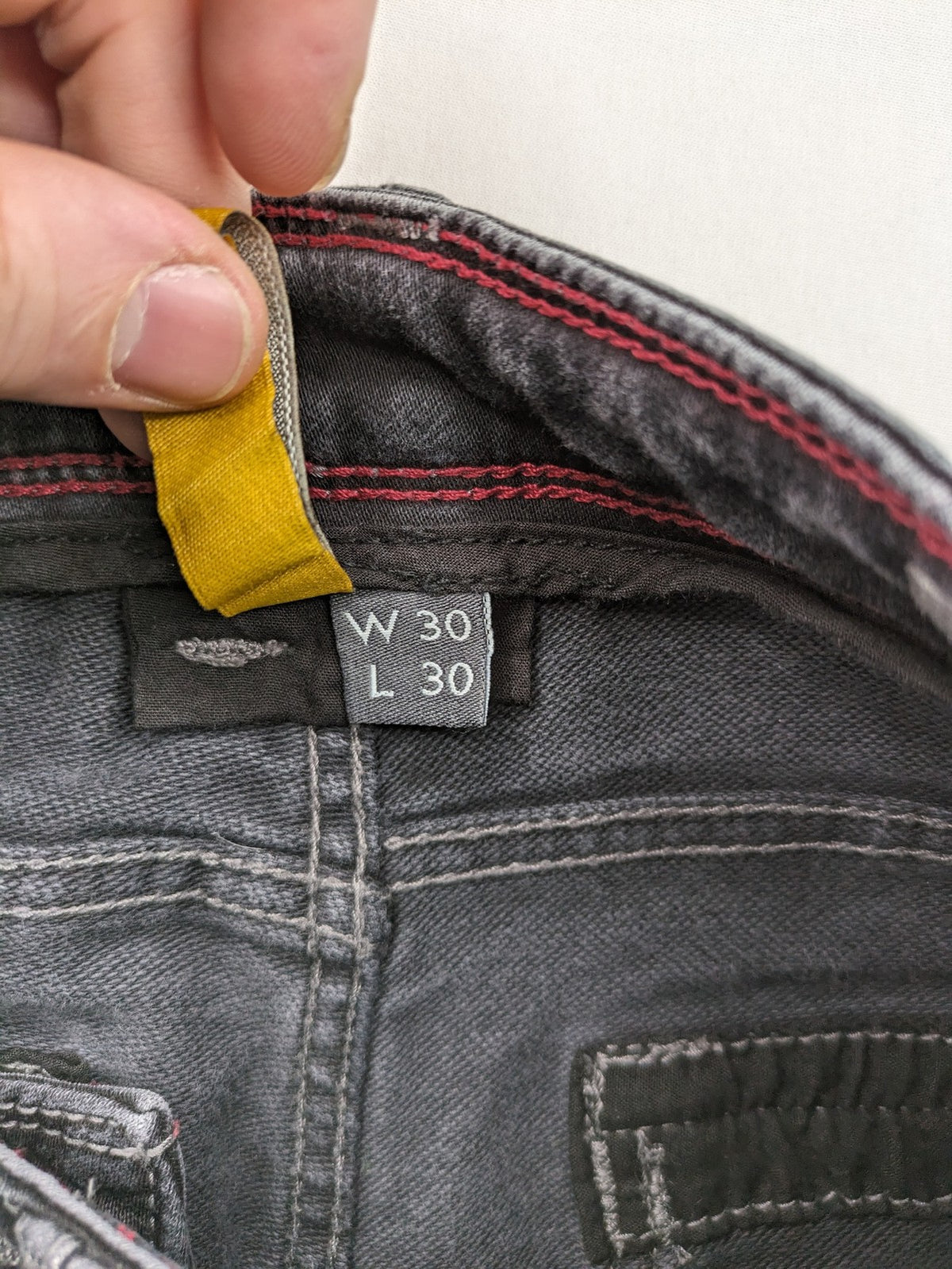 Tom Tompson grey slim tapered jeans with washed denim finish and subtle branding.