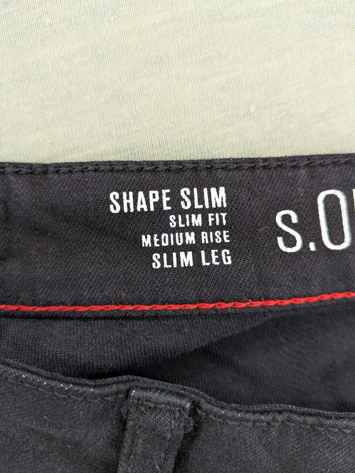s.Oliver green straight jeans with white side stripe and classic 5-pocket style.