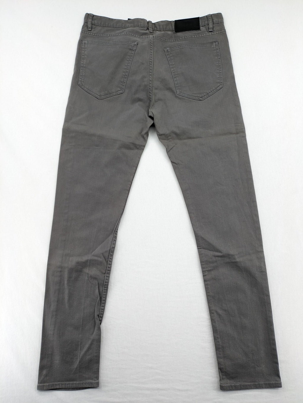 H&M grey skinny fit jeans with button closure and five-pocket design, cotton-elastane blend.