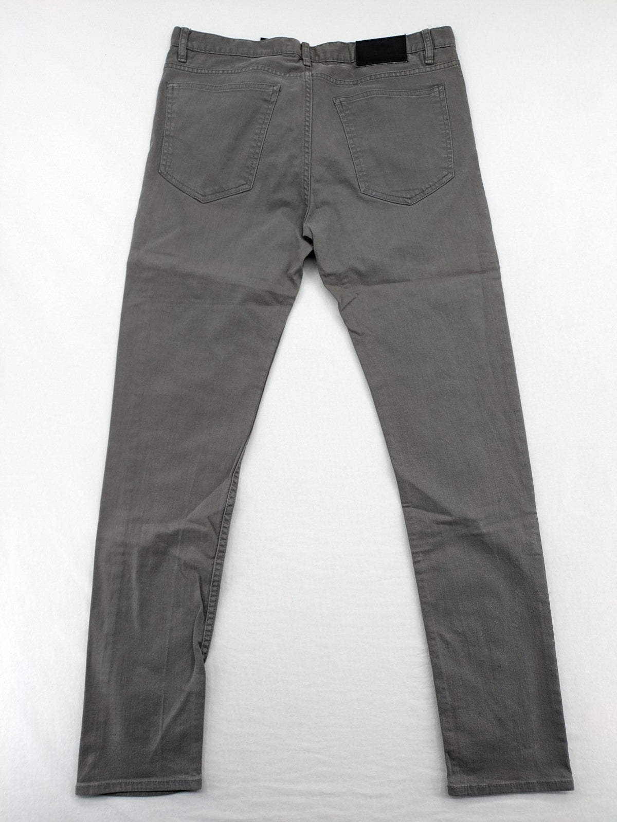 H&M grey skinny fit jeans with button closure and five-pocket design, cotton-elastane blend.