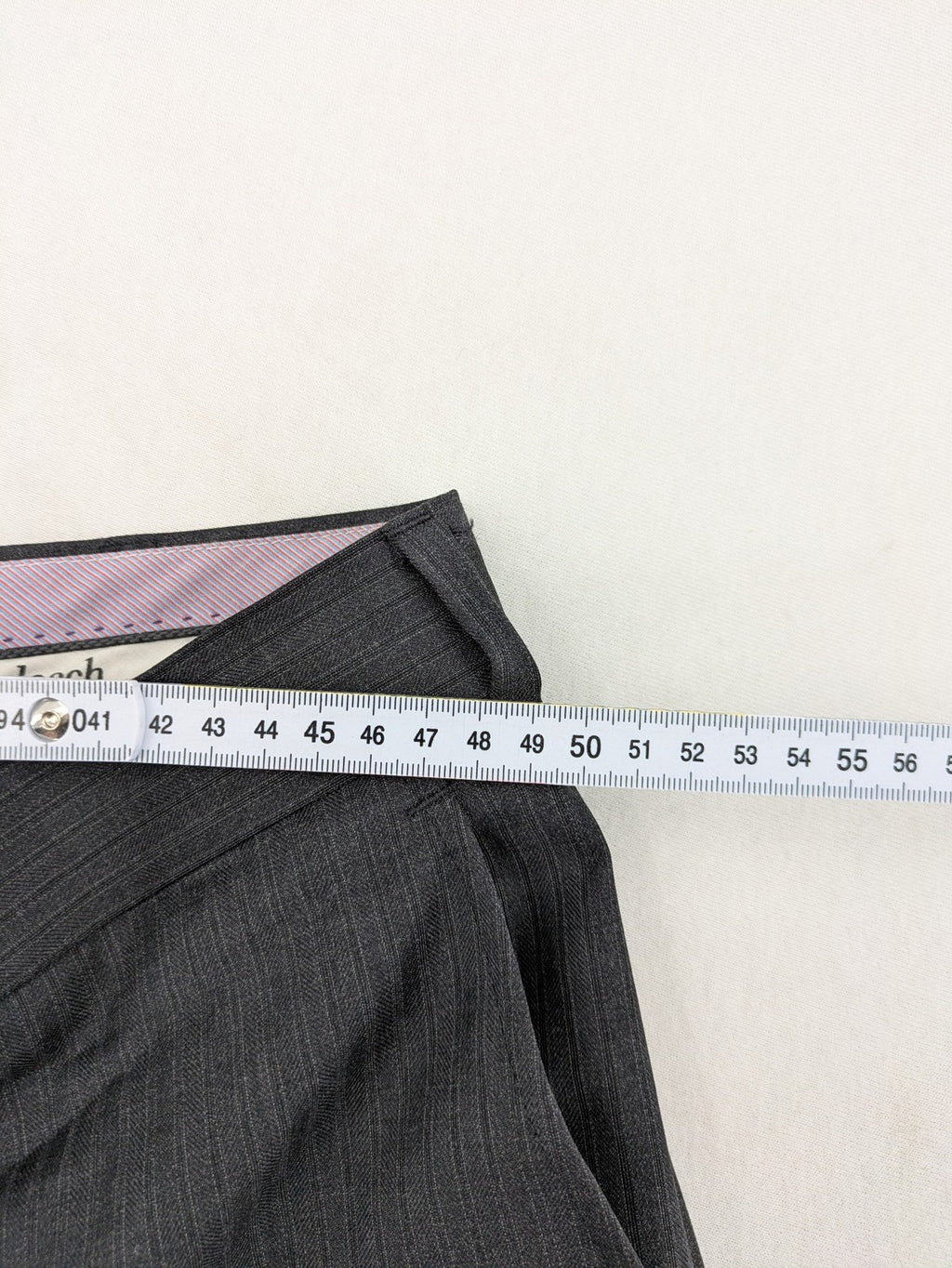 Desch grey suit pants with subtle pinstripe pattern and flat front design.