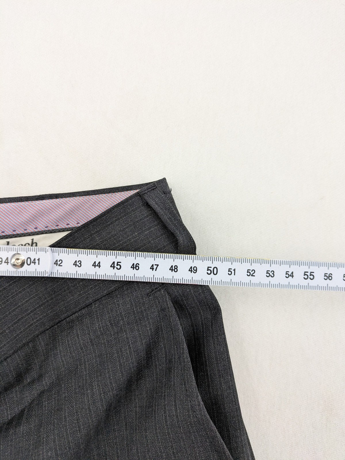 Desch grey suit pants with subtle pinstripe pattern and flat front design.