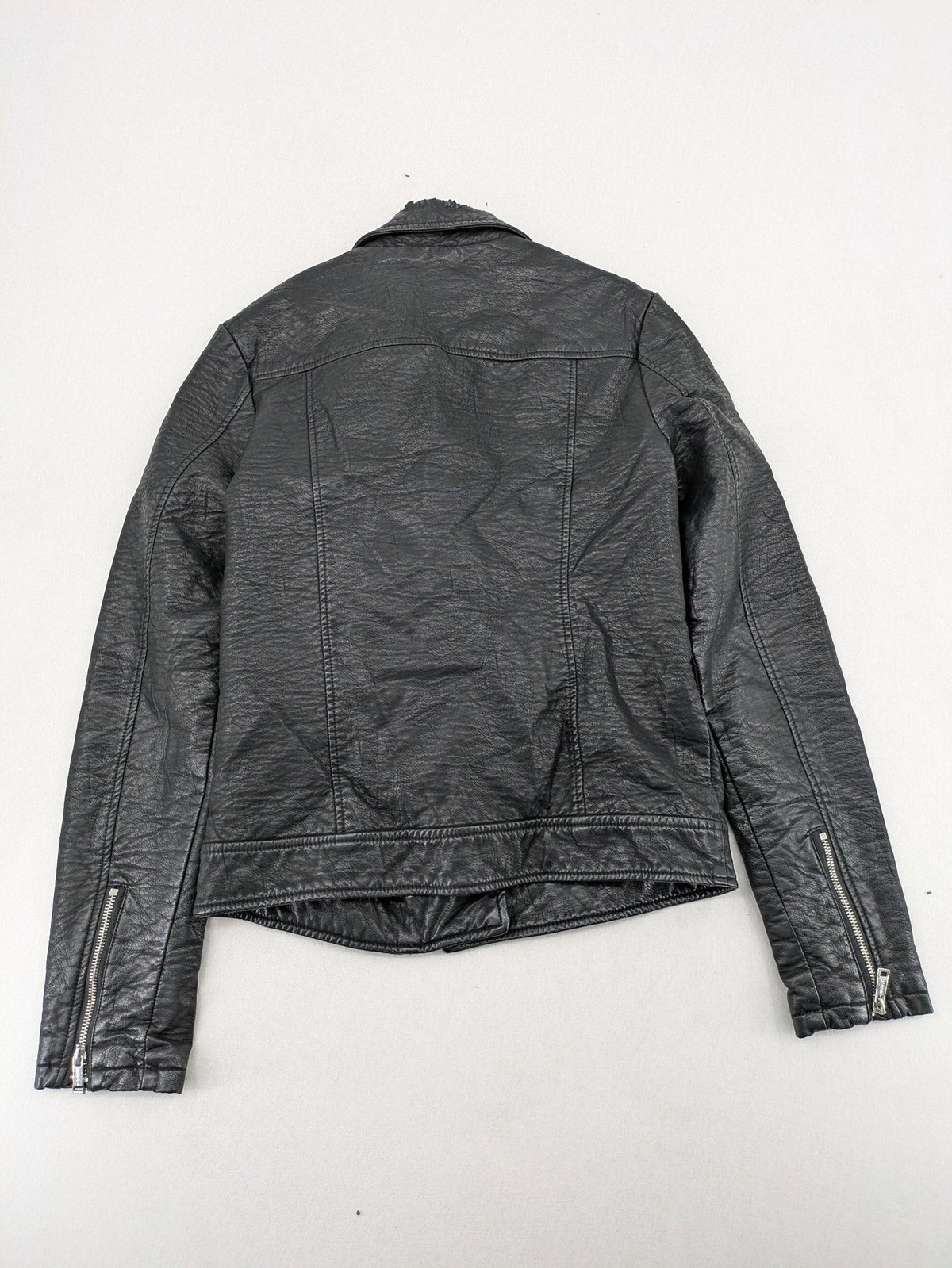 Guess black faux leather biker jacket with asymmetric zipper and multiple zip pockets.