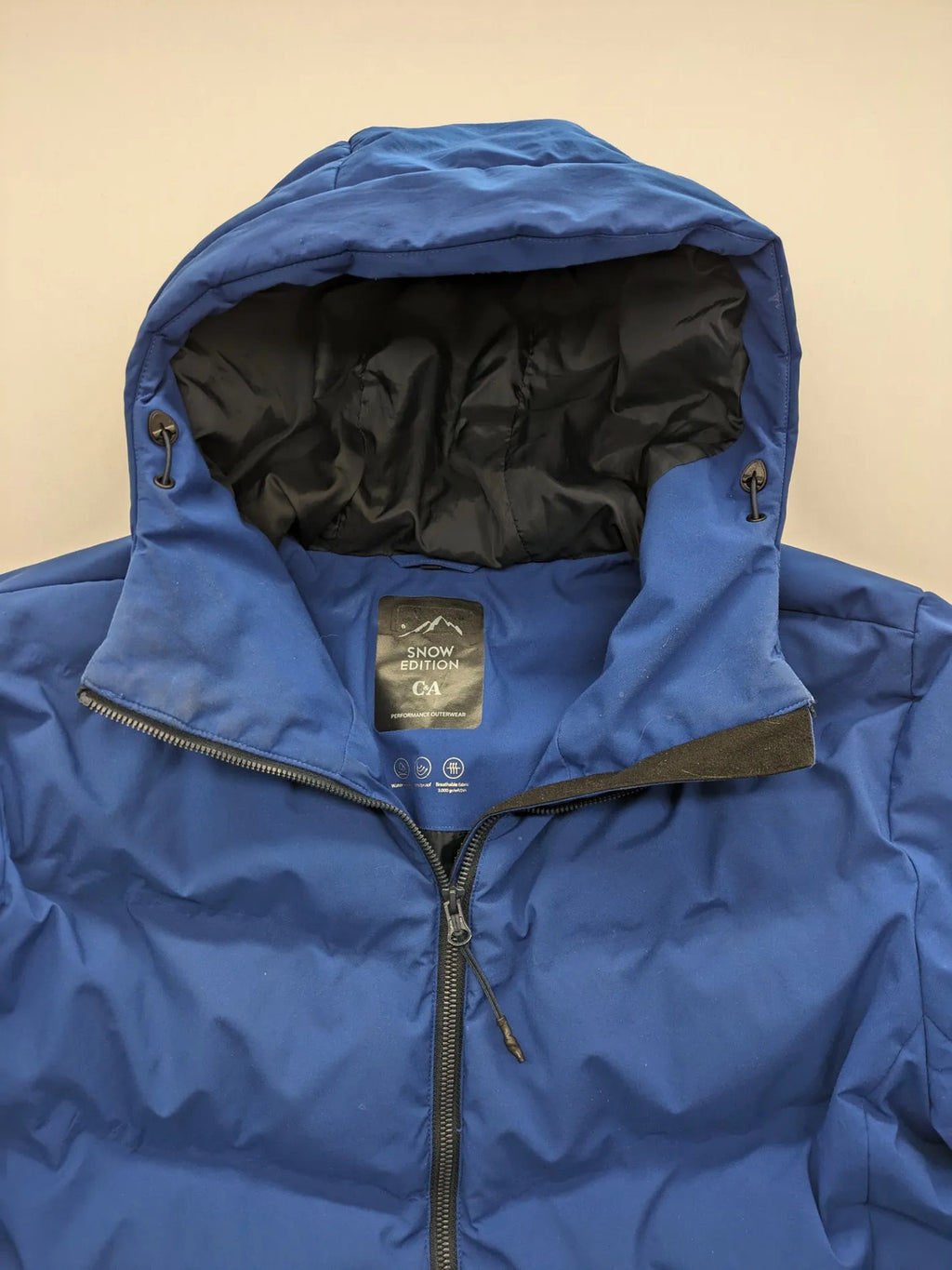 C&A blue winter jacket with hood, zip closure, and multiple pockets, used condition.