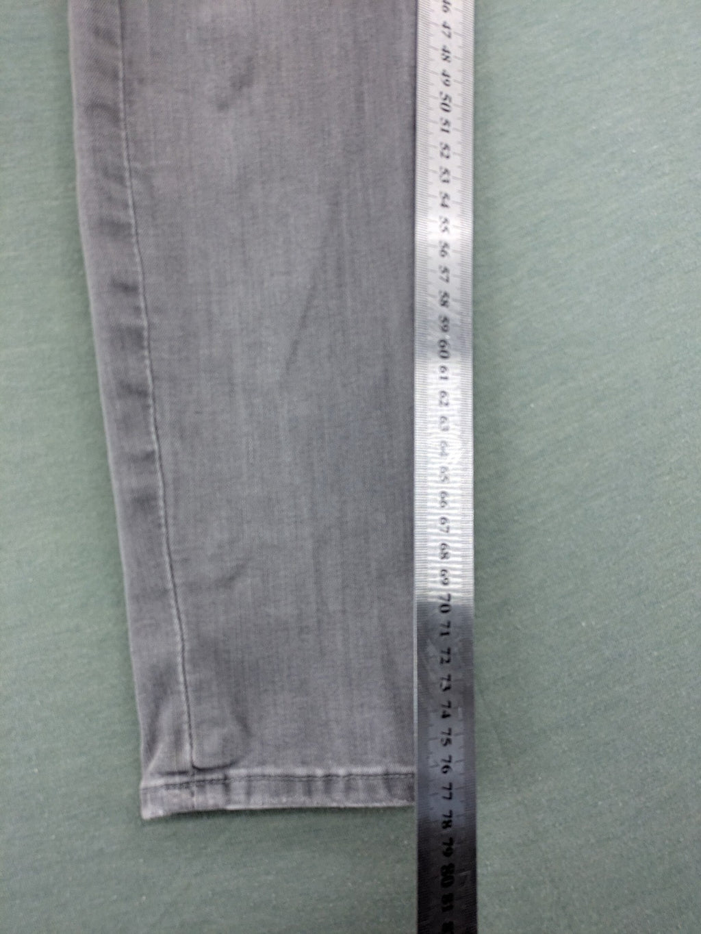 H&M grey super skinny jeans with distressed knee details and low waist fit.