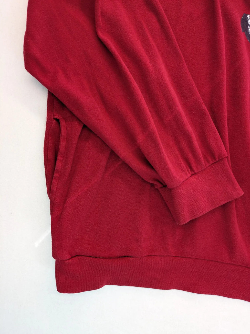 Normann red turtle neck jumper with large anchor print and side pockets.