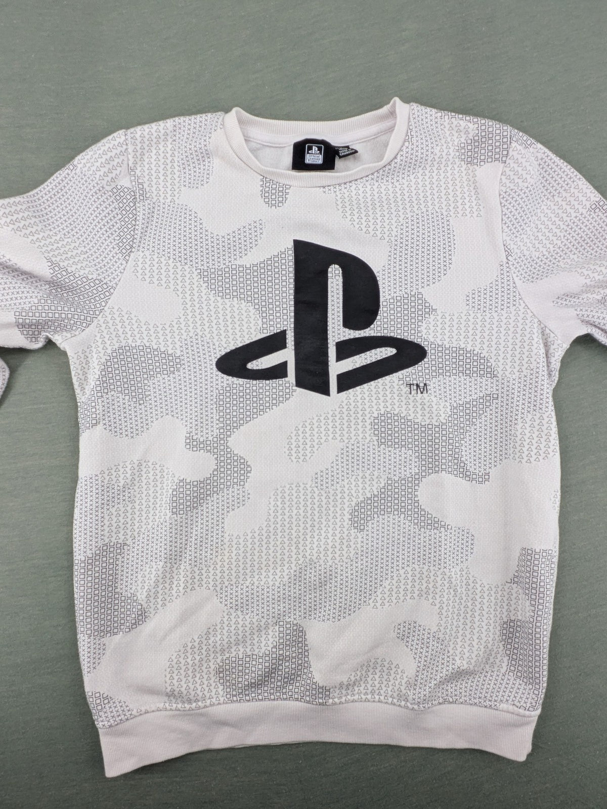 PlayStation grey sweatshirt with white logo and camo pattern featuring controller symbols.