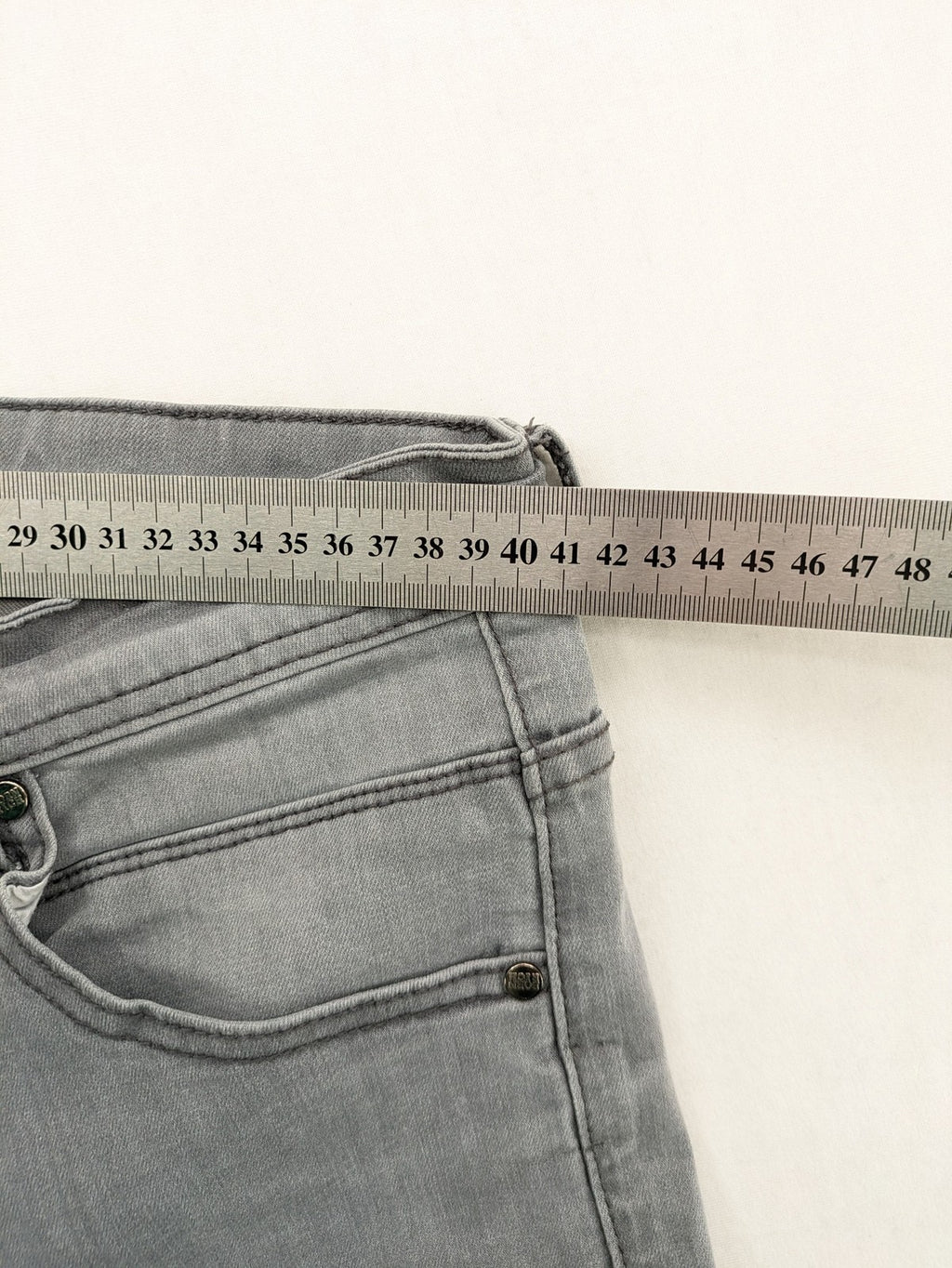 Born Rich grey slim fit jeans with logo patch and washed denim look.