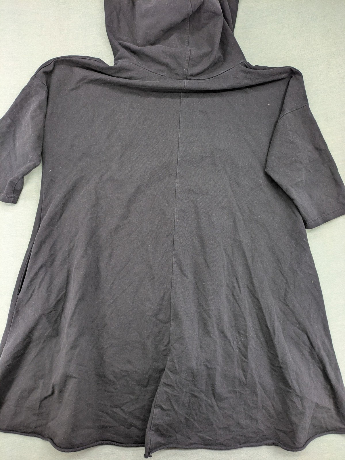 MEGI Collection black hoodie dress with graphic print and asymmetrical high-low hem.