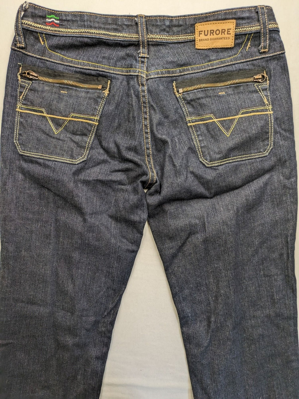 Furore blue straight jeans with yellow contrast stitching and zipper details.