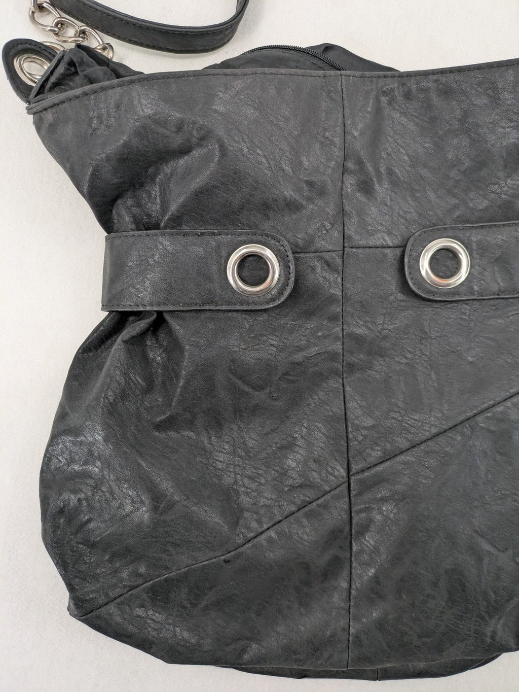 New Yorker black hobo handbag with silver chain details and large eyelets.