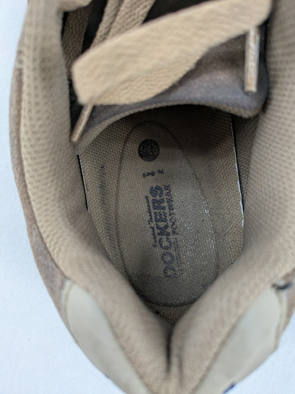Dockers brown sneakers with subtle light brown and blue accents, lace-up design.
