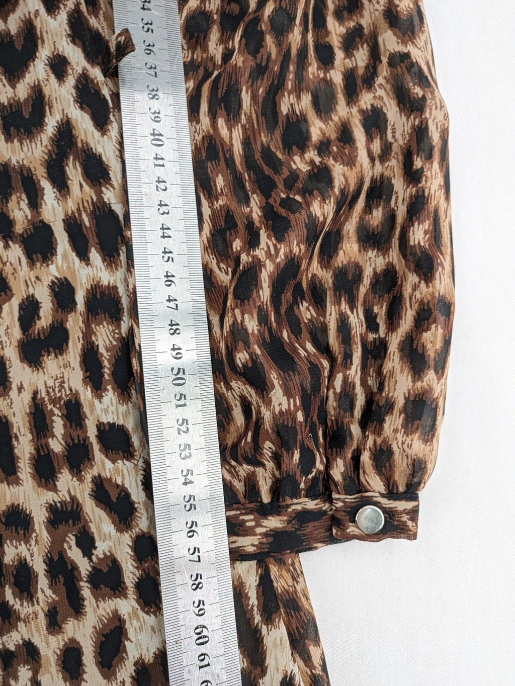 Atmosphere beige leopard print dress with sheer chiffon sleeves and buttoned cuffs.