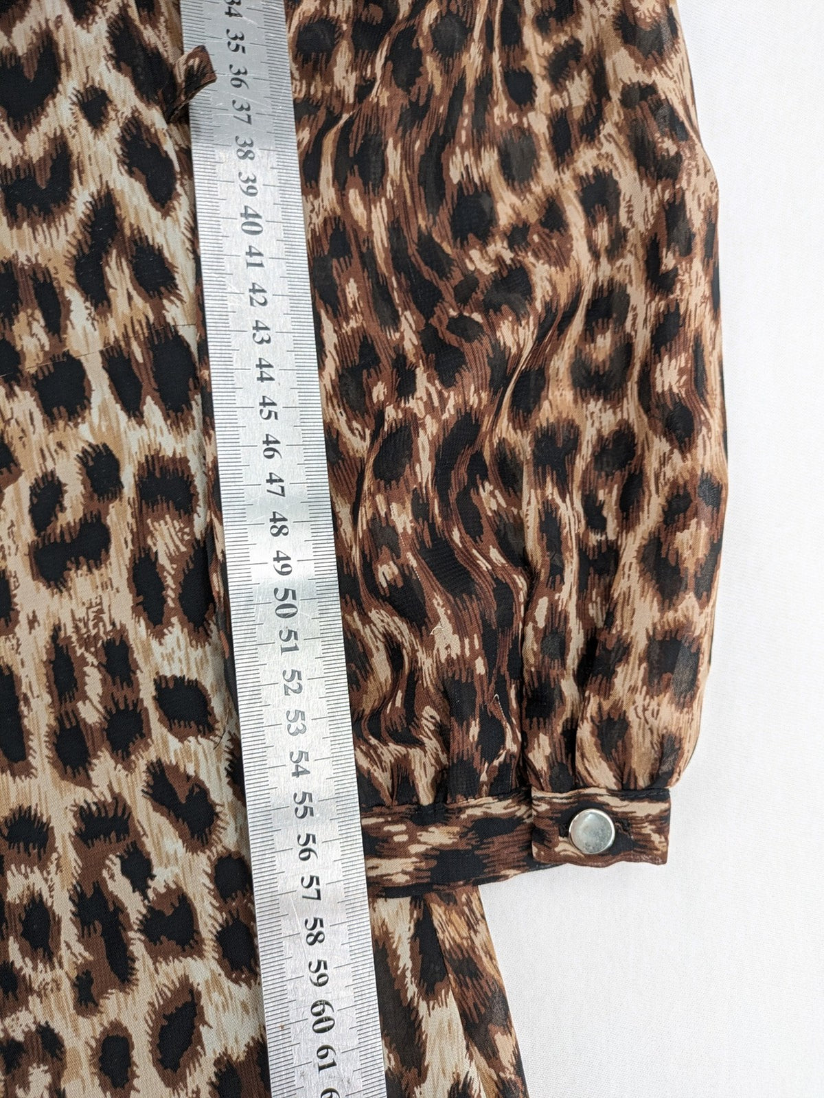 Atmosphere beige leopard print dress with sheer chiffon sleeves and buttoned cuffs.
