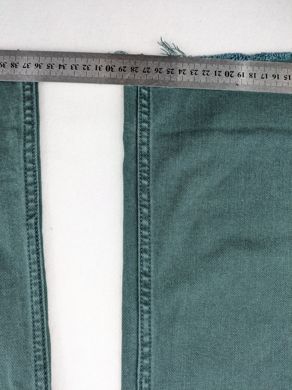 Zara green high waist wide leg jeans with frayed hem and button closure.