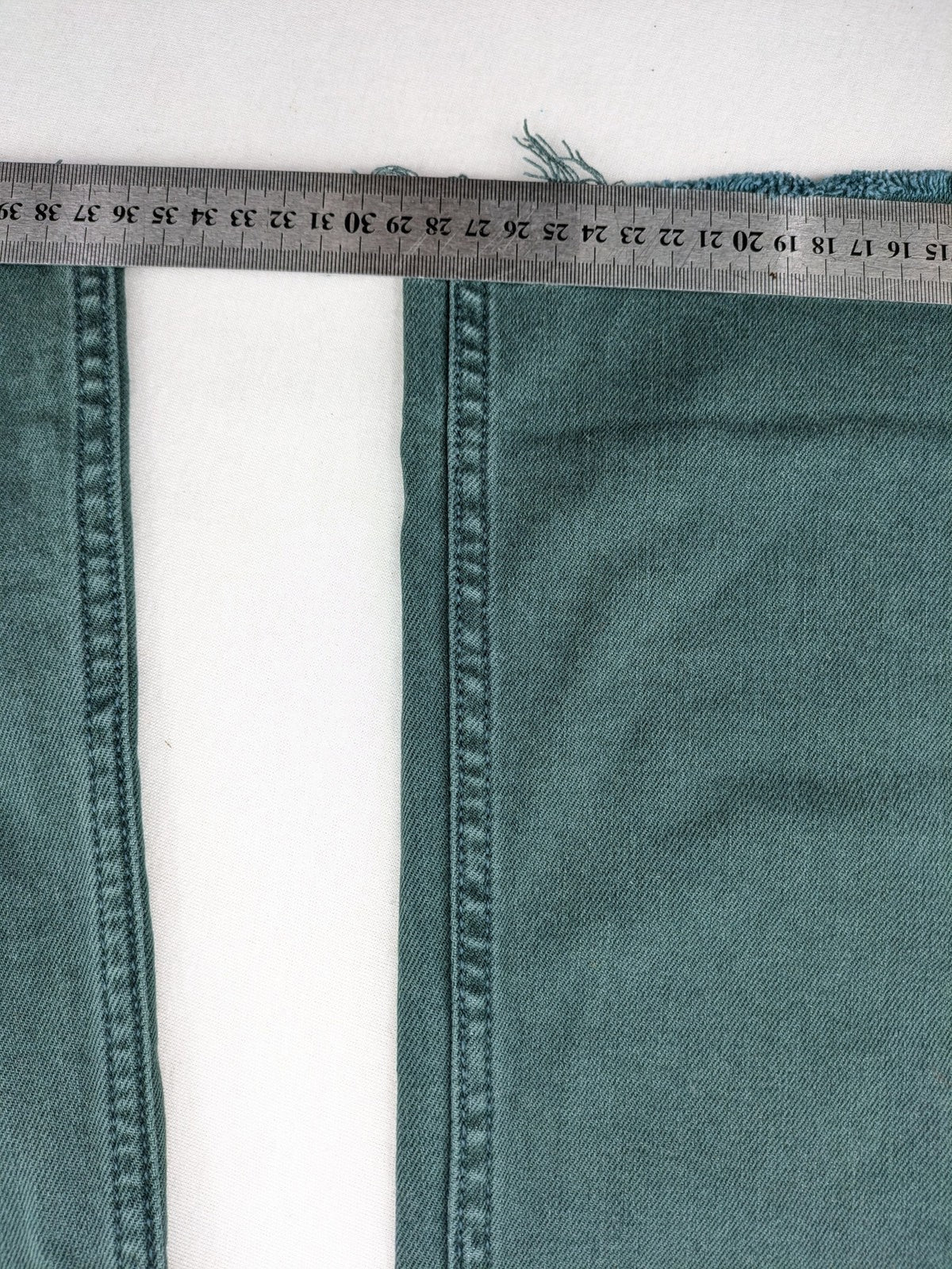 Zara green high waist wide leg jeans with frayed hem and button closure.