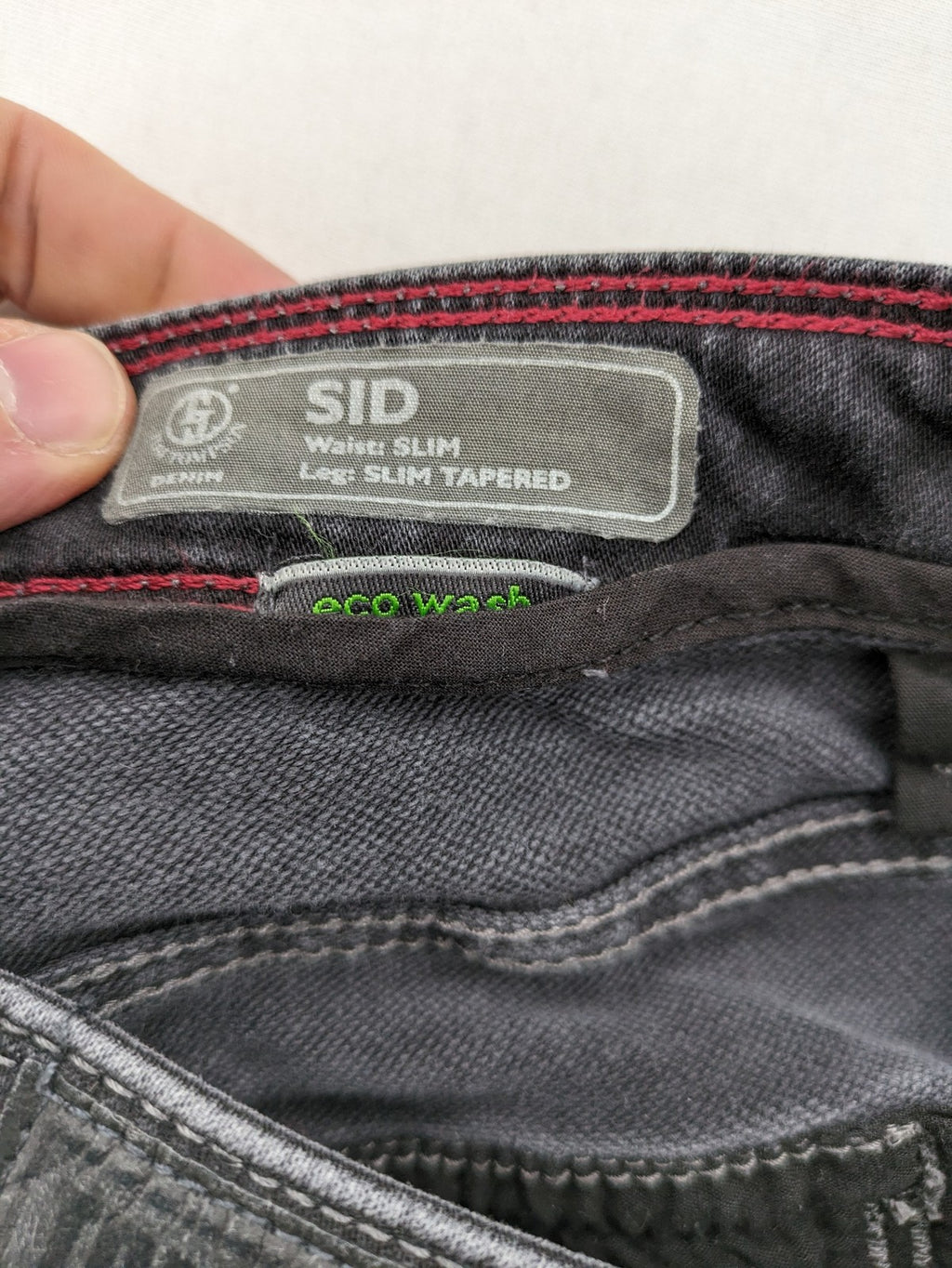 Tom Tompson grey slim tapered jeans with washed denim finish and subtle branding.