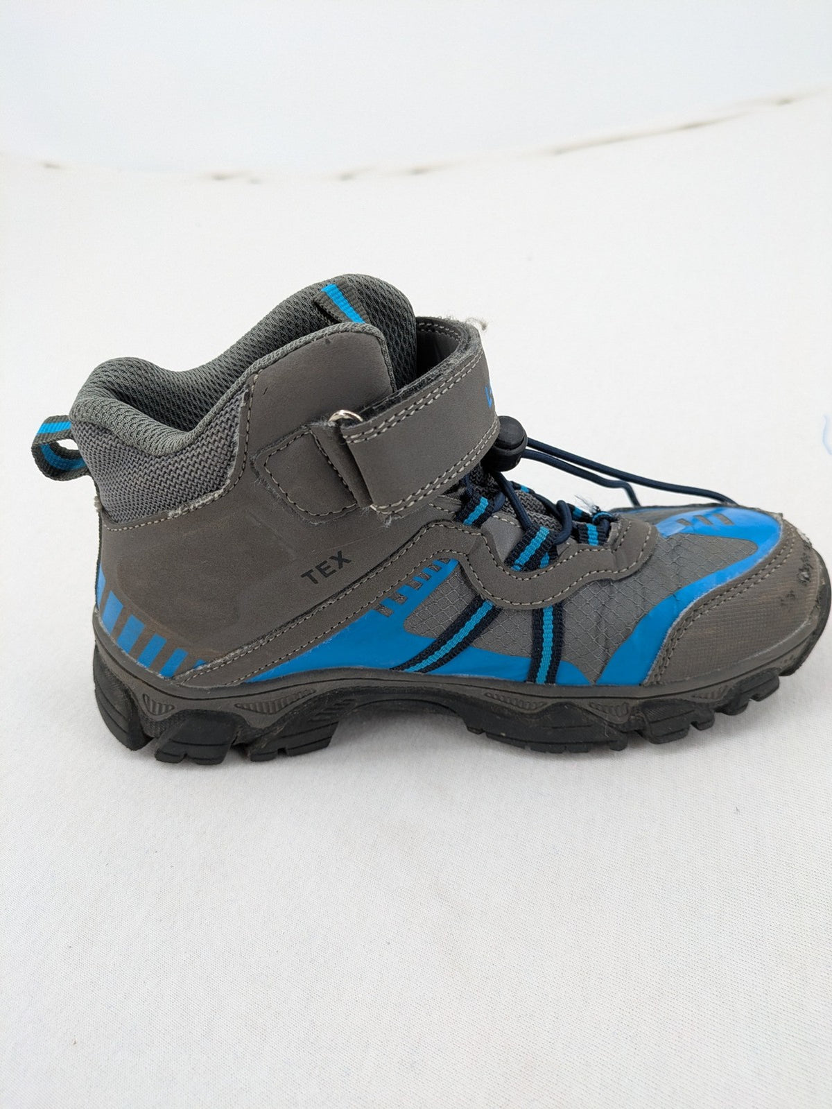 Outdoor grey and blue winter boots with high shaft, Velcro closure, and textured sole.