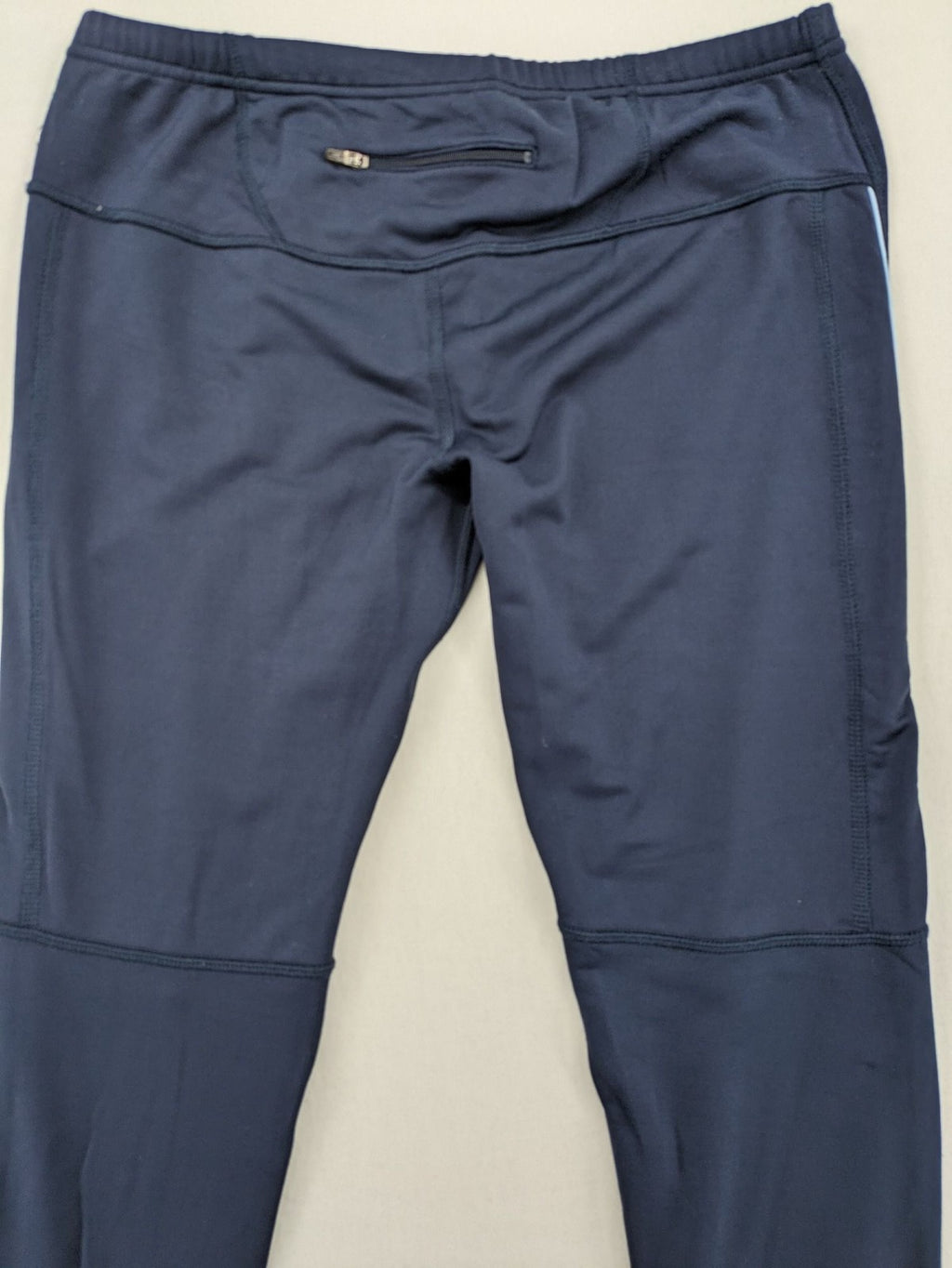 Crane Sports navy running tights with reflective details and zippered ankle openings.