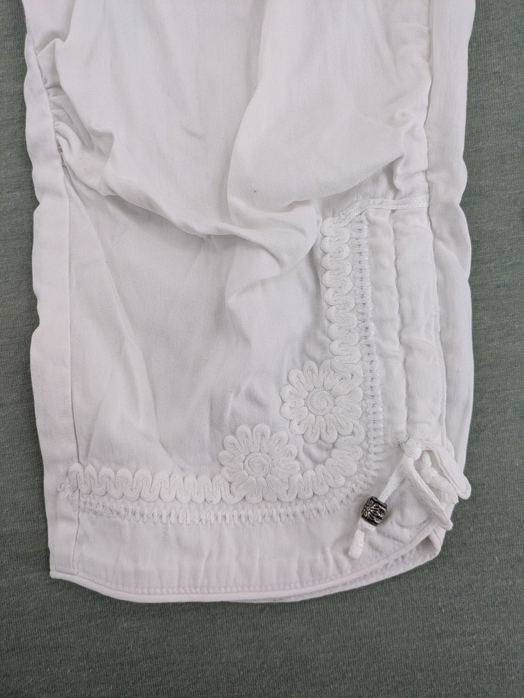 TREDY white capri pants with delicate floral embroidery and wide comfort waistband.