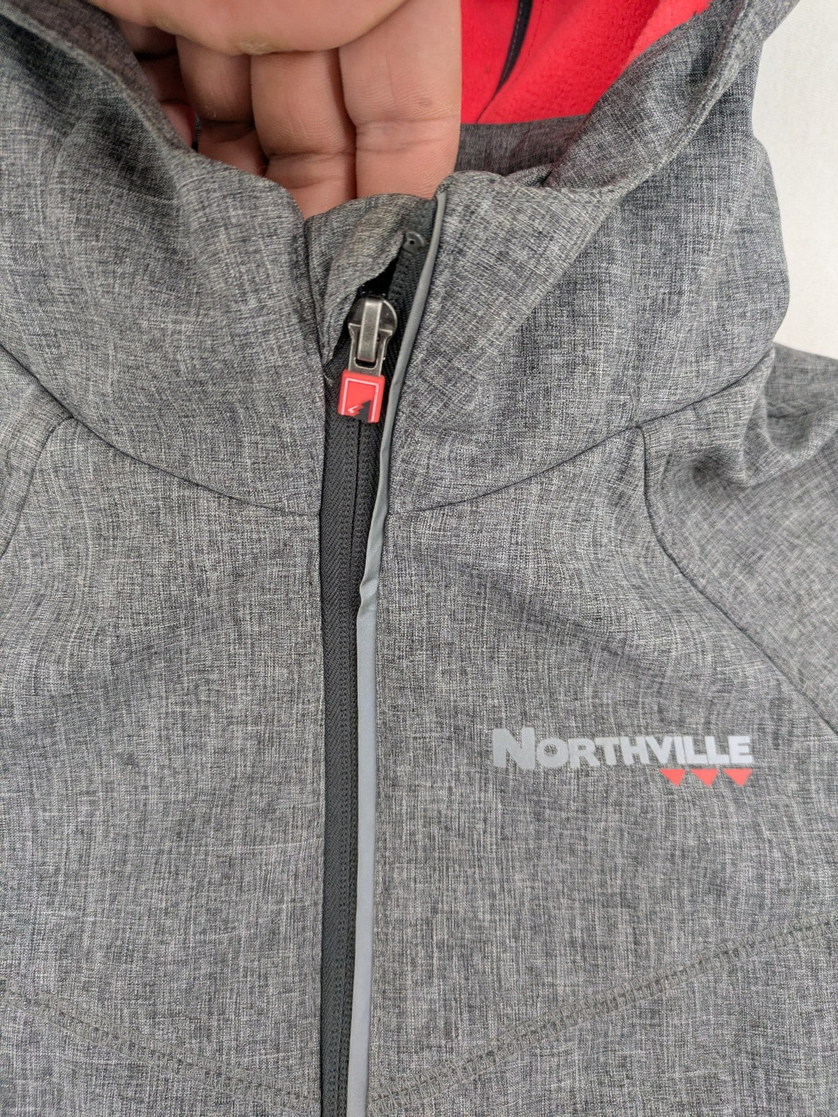 Northville grey and red softshell jacket with hood, fleece lining, and reflective elements.