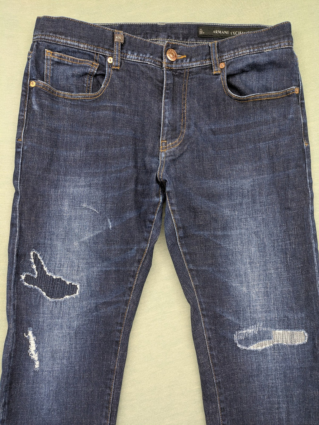 Armani Exchange blue slim fit jeans with distressed details and classic 5-pocket design.