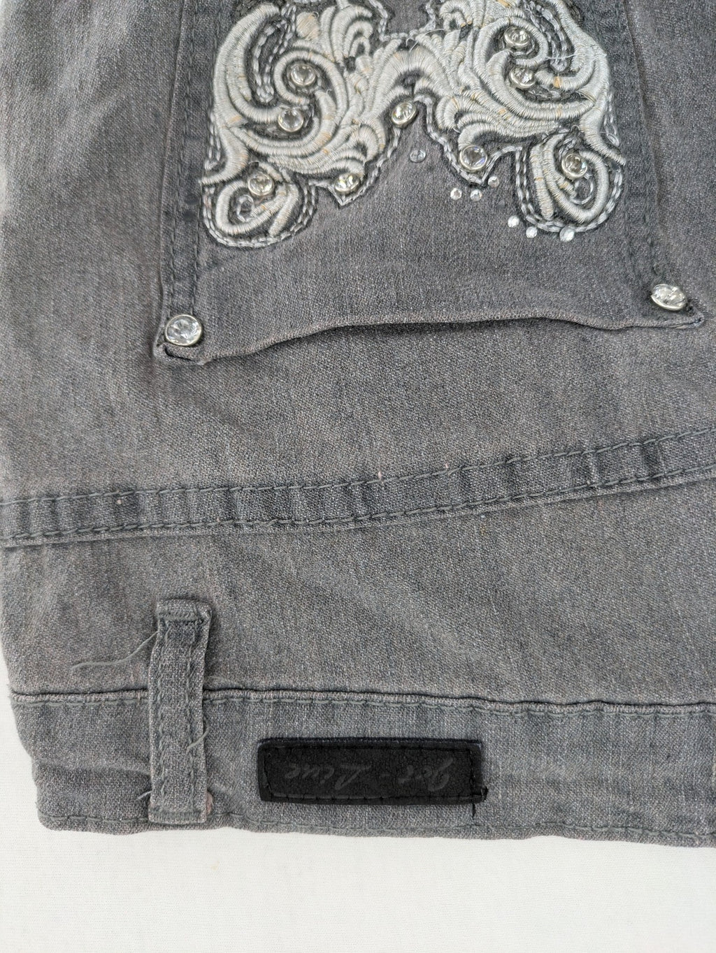 Jet Line grey straight jeans with embellished back pockets and frayed hem details.