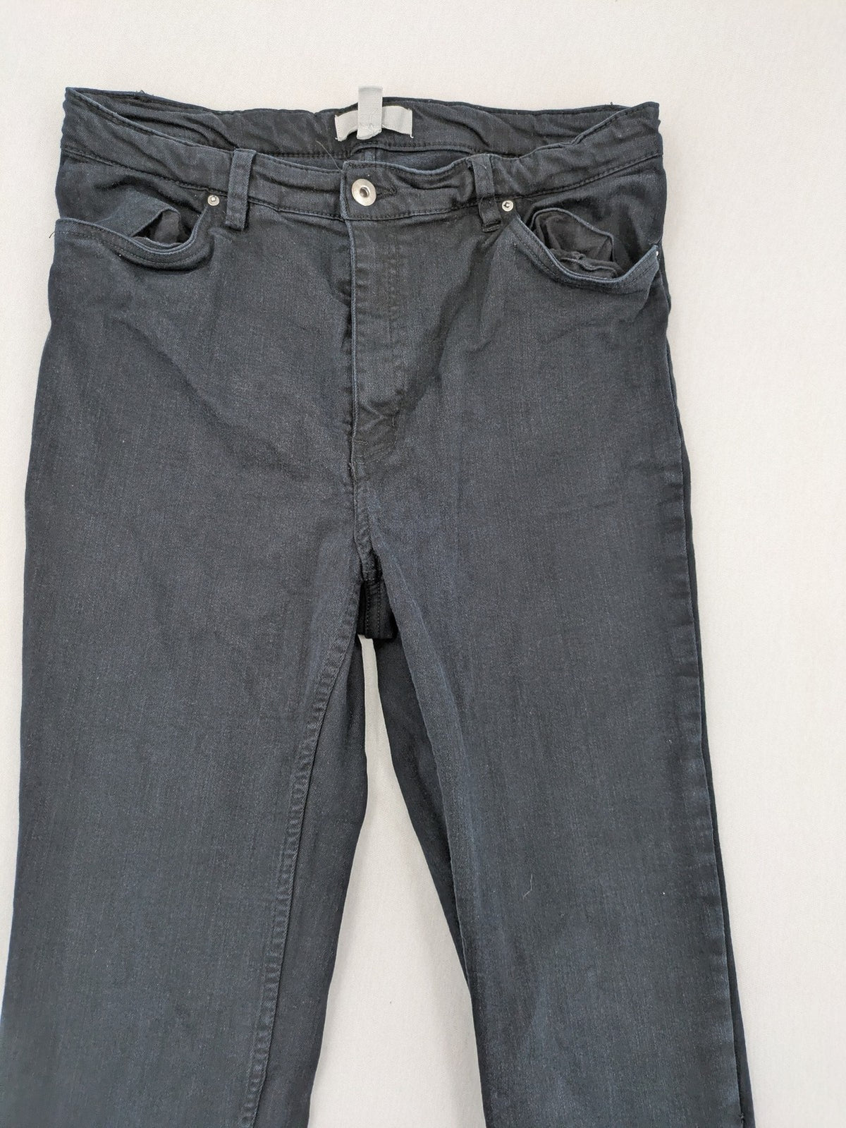 H&M grey skinny jeans with faded wash and soft stretch denim material.