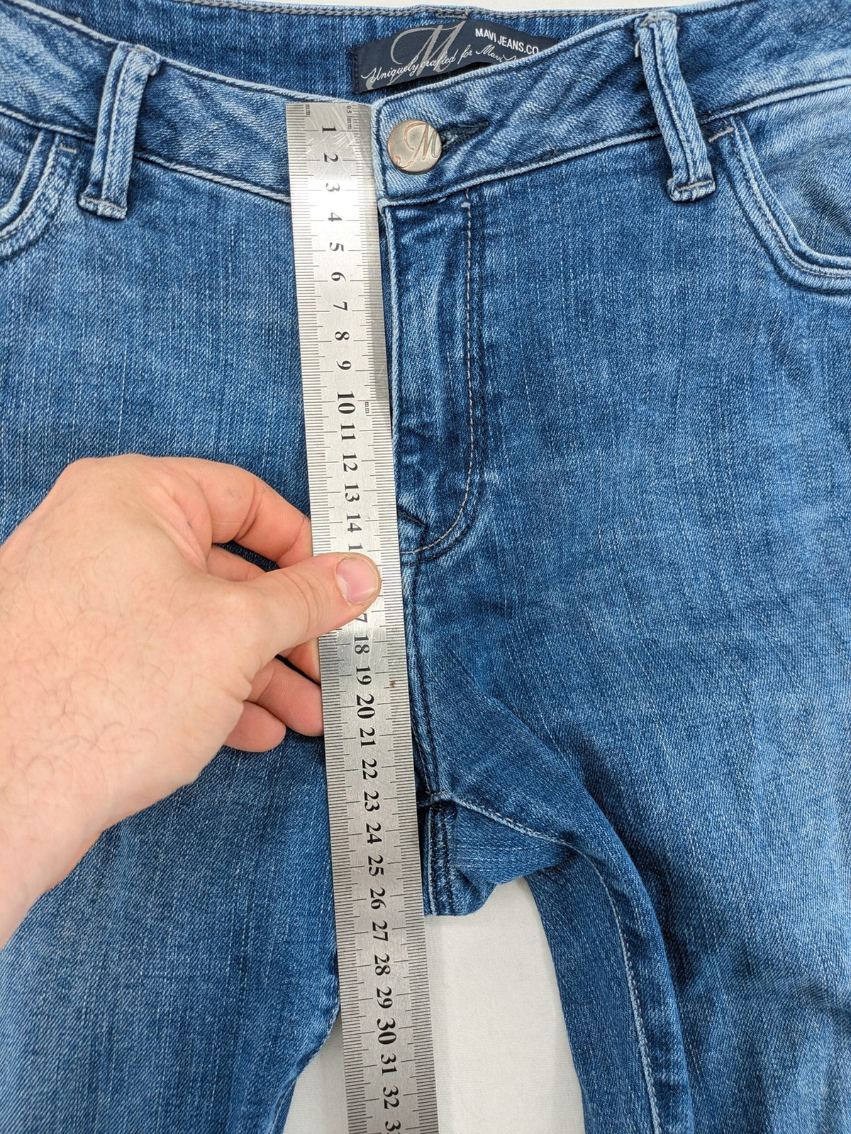 Mavi blue straight leg jeans with classic 5-pocket styling and medium wash.