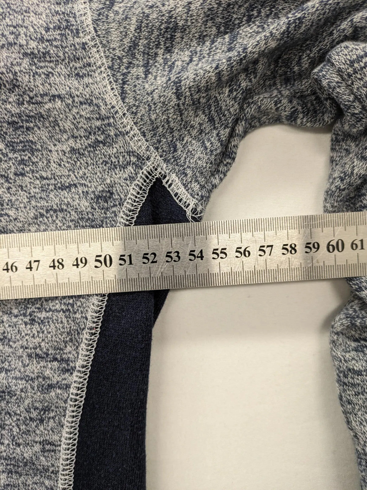 Tom Tompson cream turtle neck jumper with dark blue accents and graphic details on sleeve.