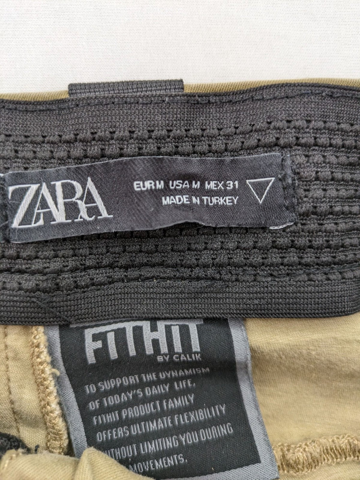 Zara khaki pants with elastic waistband, made from stretch cotton blend for comfort.
