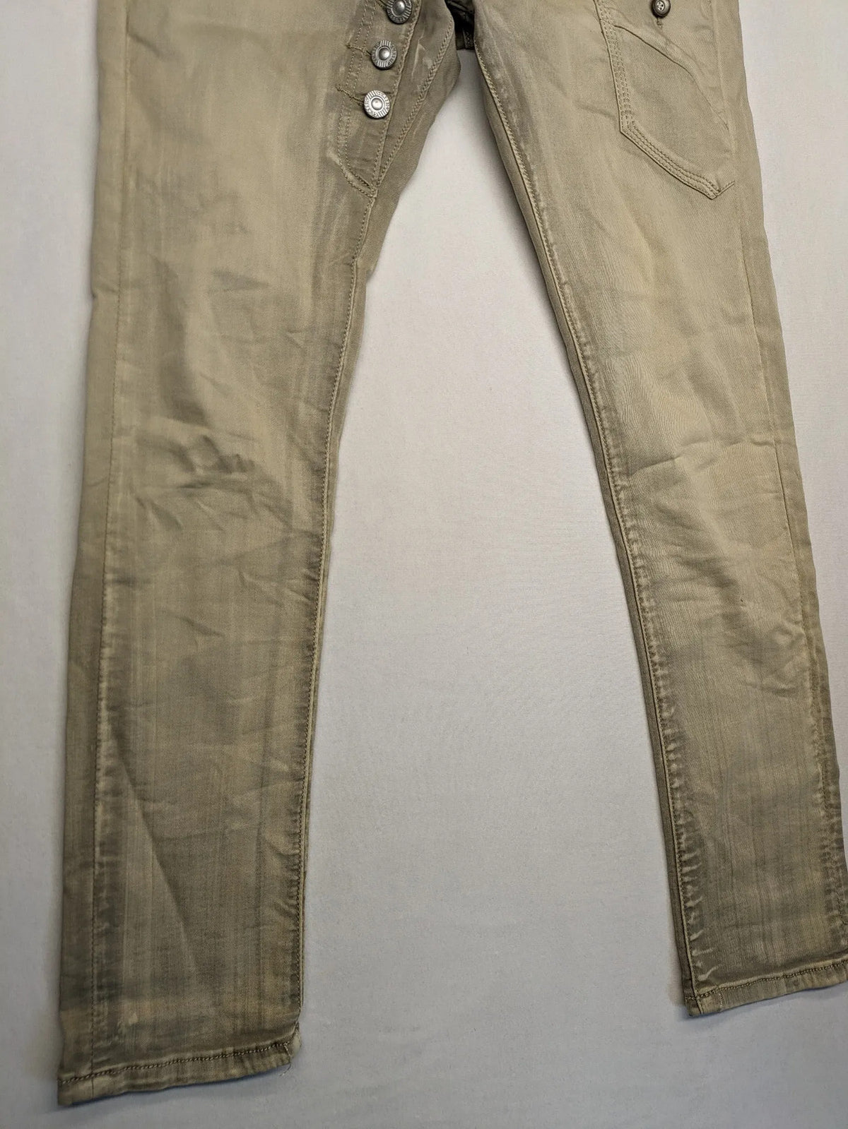 Mozaar beige straight jeans with unique asymmetrical button placket and practical pockets.