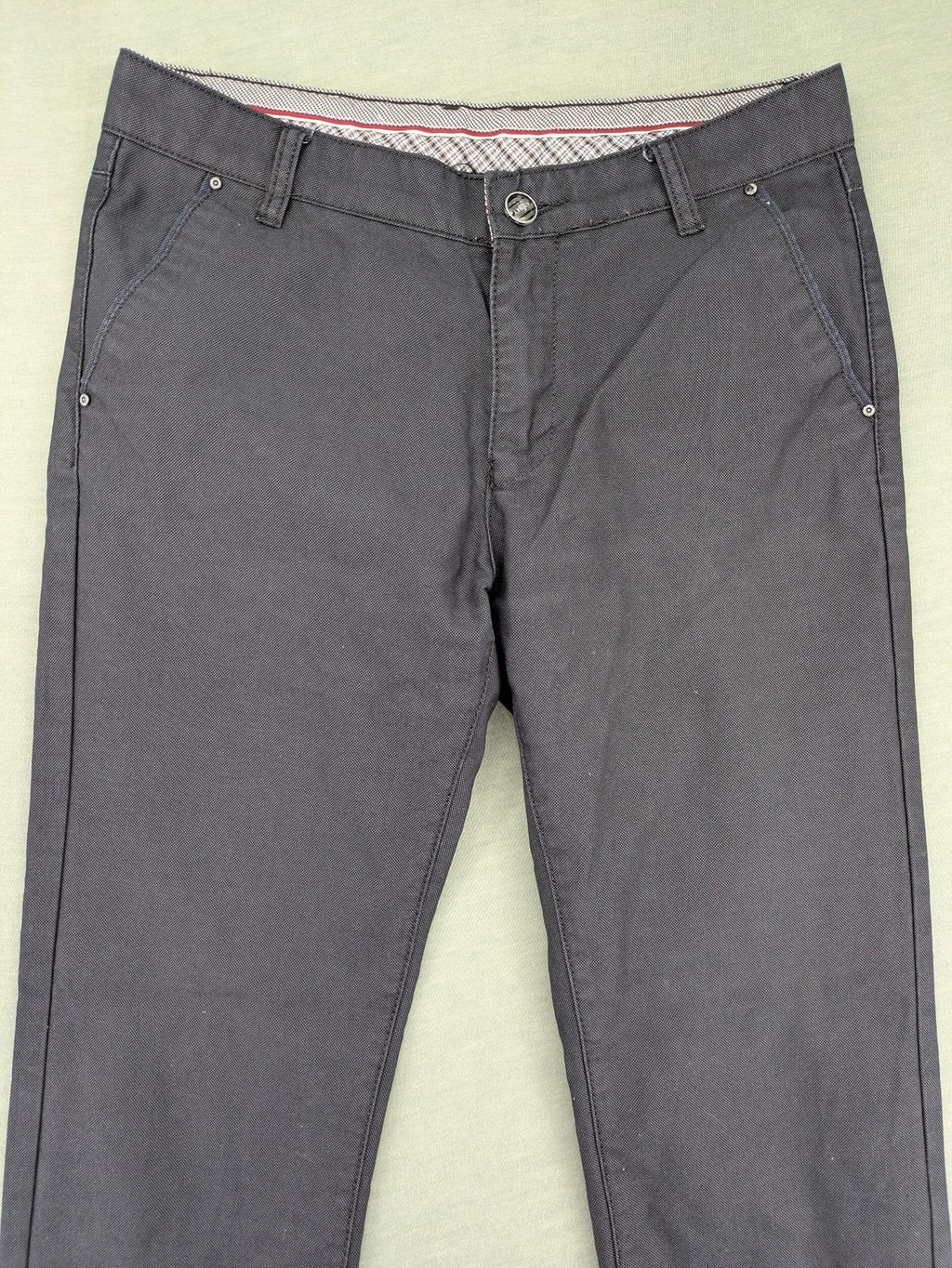 Rooney grey chino pants with checkered waistband and buttoned back pockets.