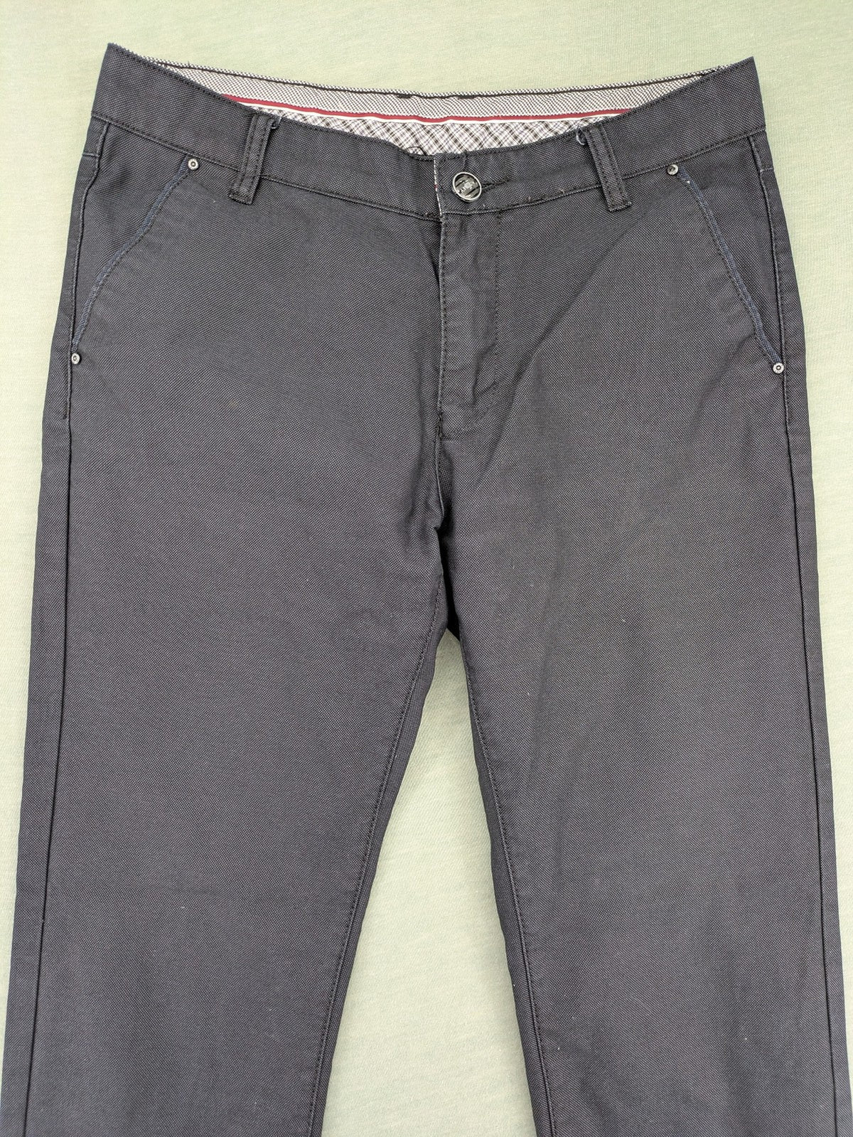 Rooney grey chino pants with checkered waistband and buttoned back pockets.