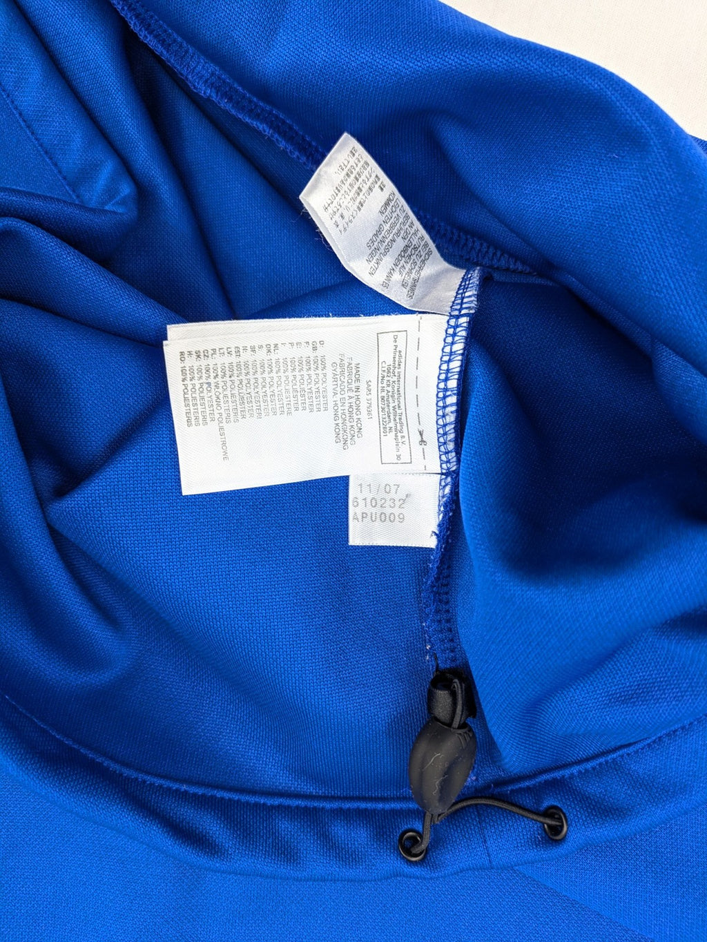 Adidas blue long sleeve top with white three stripes and 1/4 zip collar.