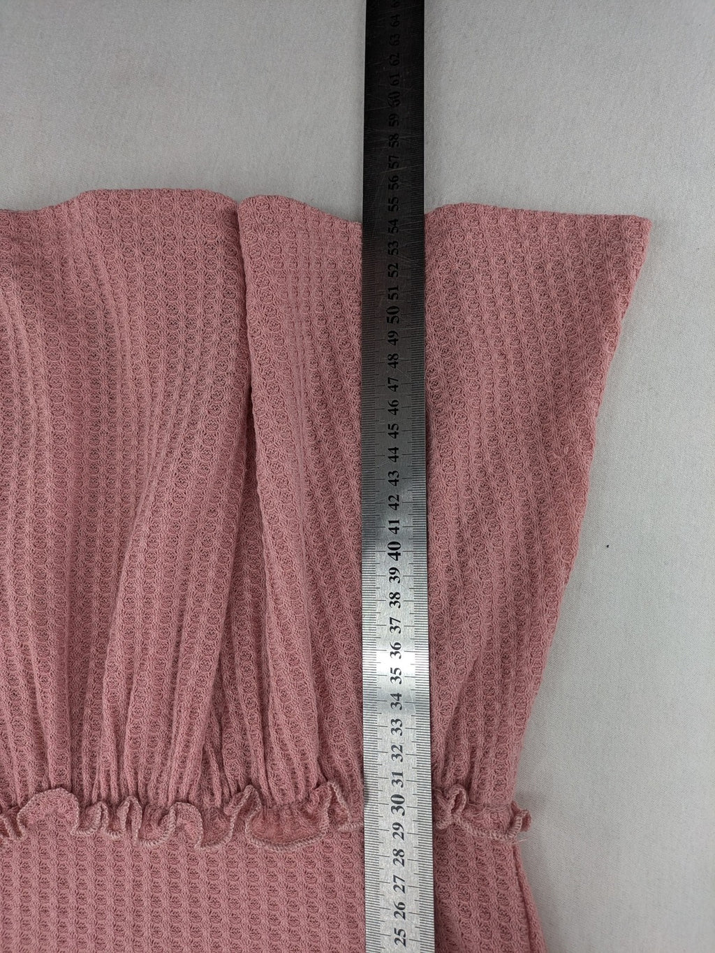 SHEIN pink top V-neck with ruffled waist and three decorative buttons, waffle knit fabric.