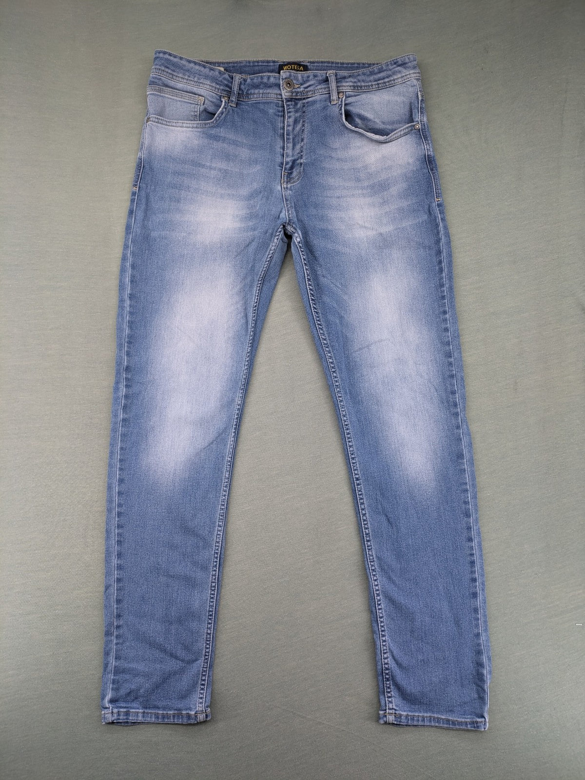 Wotega blue straight jeans light wash faded with classic 5-pocket design and stretch material.