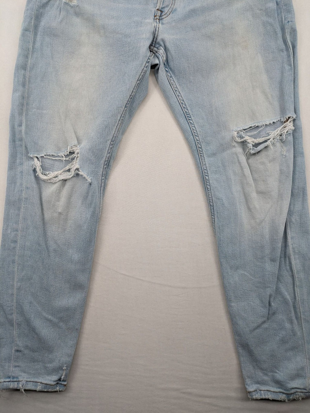 Zara blue straight jeans with distressed knees and classic button fly.