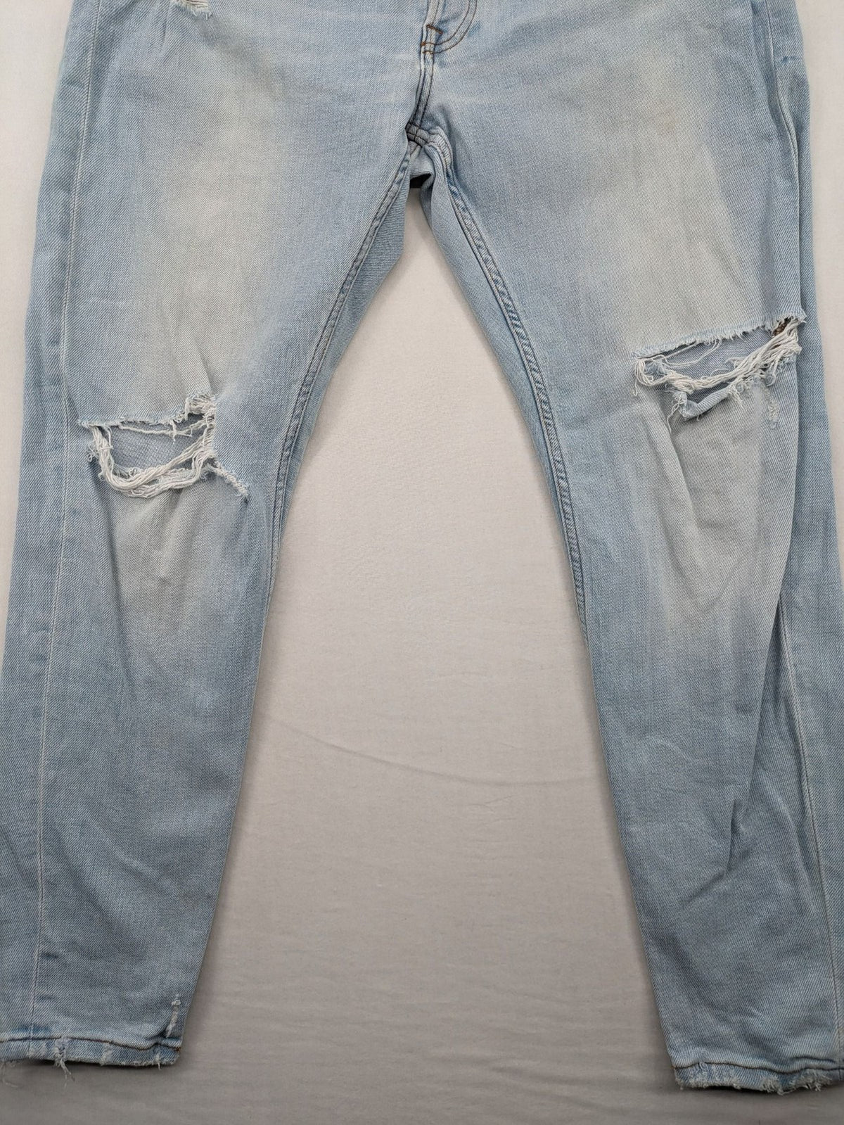 Zara blue straight jeans with distressed knees and classic button fly.