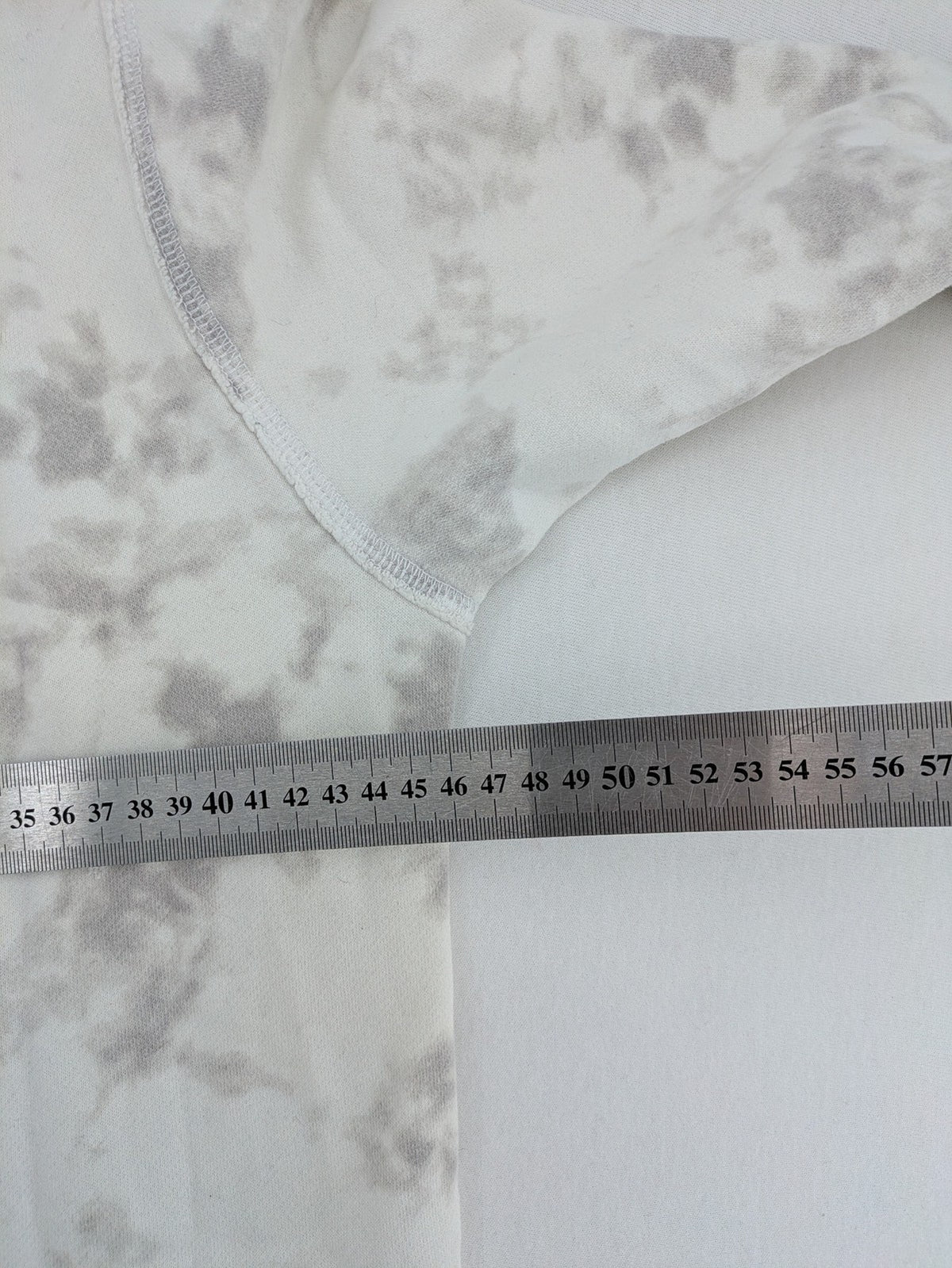 Hollister grey and white tie-dye hoodie with logo on chest, back, and sleeve.