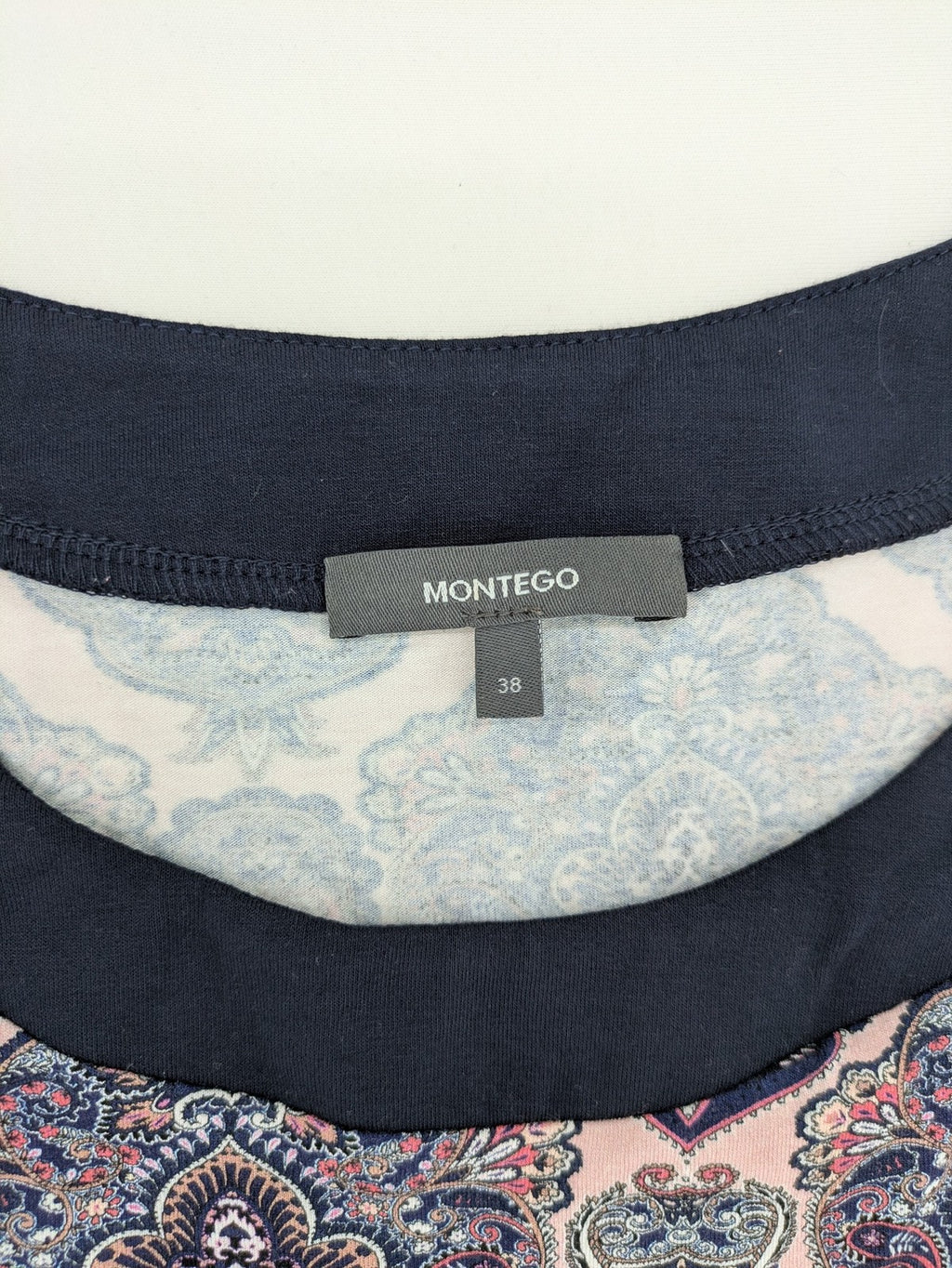 Montego pink sleeveless dress with paisley pattern and black hem, made of viscose.