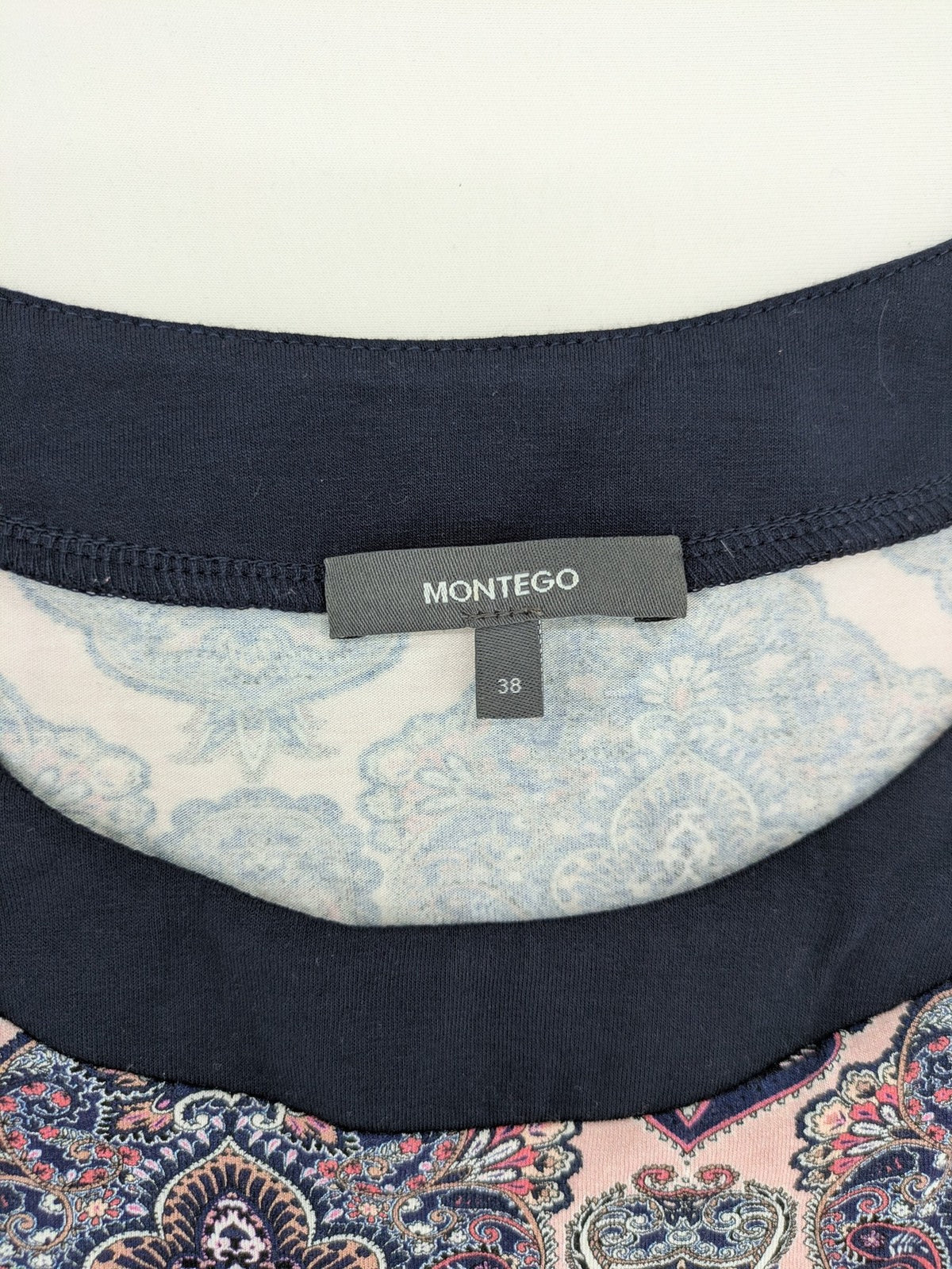 Montego pink sleeveless dress with paisley pattern and black hem, made of viscose.
